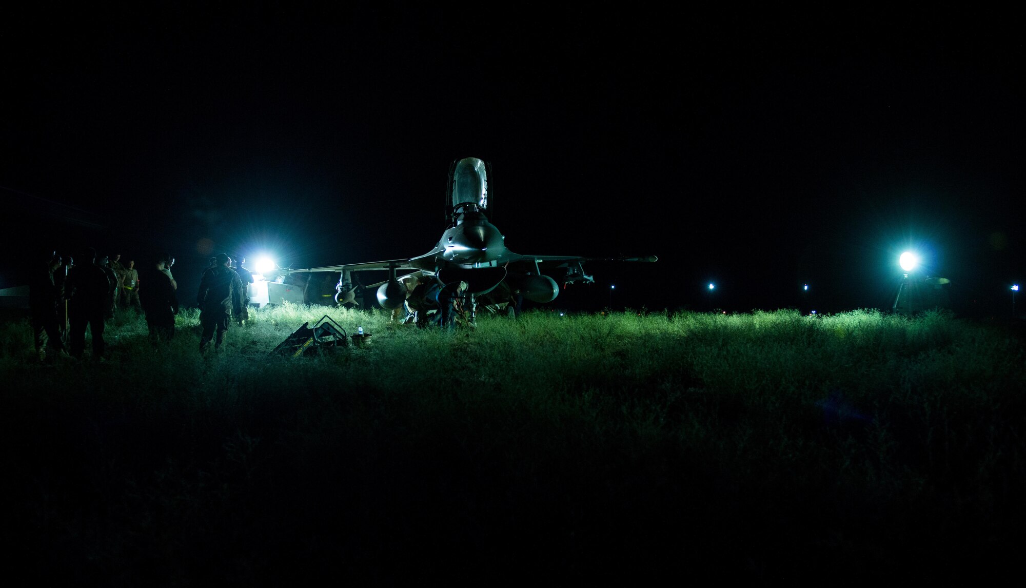 U.S. Airmen assigned to the 455th Expeditionary Aircraft Maintenance Squadron work to replace a tire on an F-16 Fighting Falcon aircraft that departed the runway while landing at Bagram Air Field, Afghanistan, May 4, 2015. The 455th EAMXS maintainers were able to expeditiously recover the aircraft and return the runway to operational status; the pilot was uninjured while the F-16 only sustained minor damage in the mishap. (U.S. Air Force photo by Tech Sgt. Joseph Swafford/Released)