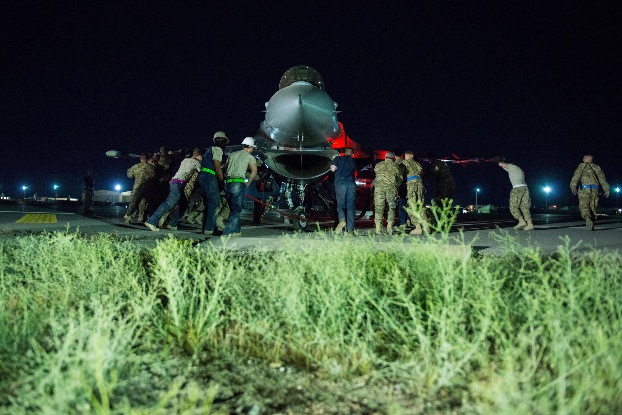 U.S. Airmen assigned to the 455th Expeditionary Aircraft Maintenance Squadron move an F-16 Fighting Falcon aircraft that had departed the runway while landing at Bagram Air Field, Afghanistan, May 4, 2015. The 455th EAMXS maintainers were able to expeditiously recover the aircraft and return the runway to operational status; the pilot was uninjured while the F-16 only sustained minor damage in the mishap. (U.S. Air Force photo by Tech Sgt. Joseph Swafford/Released)