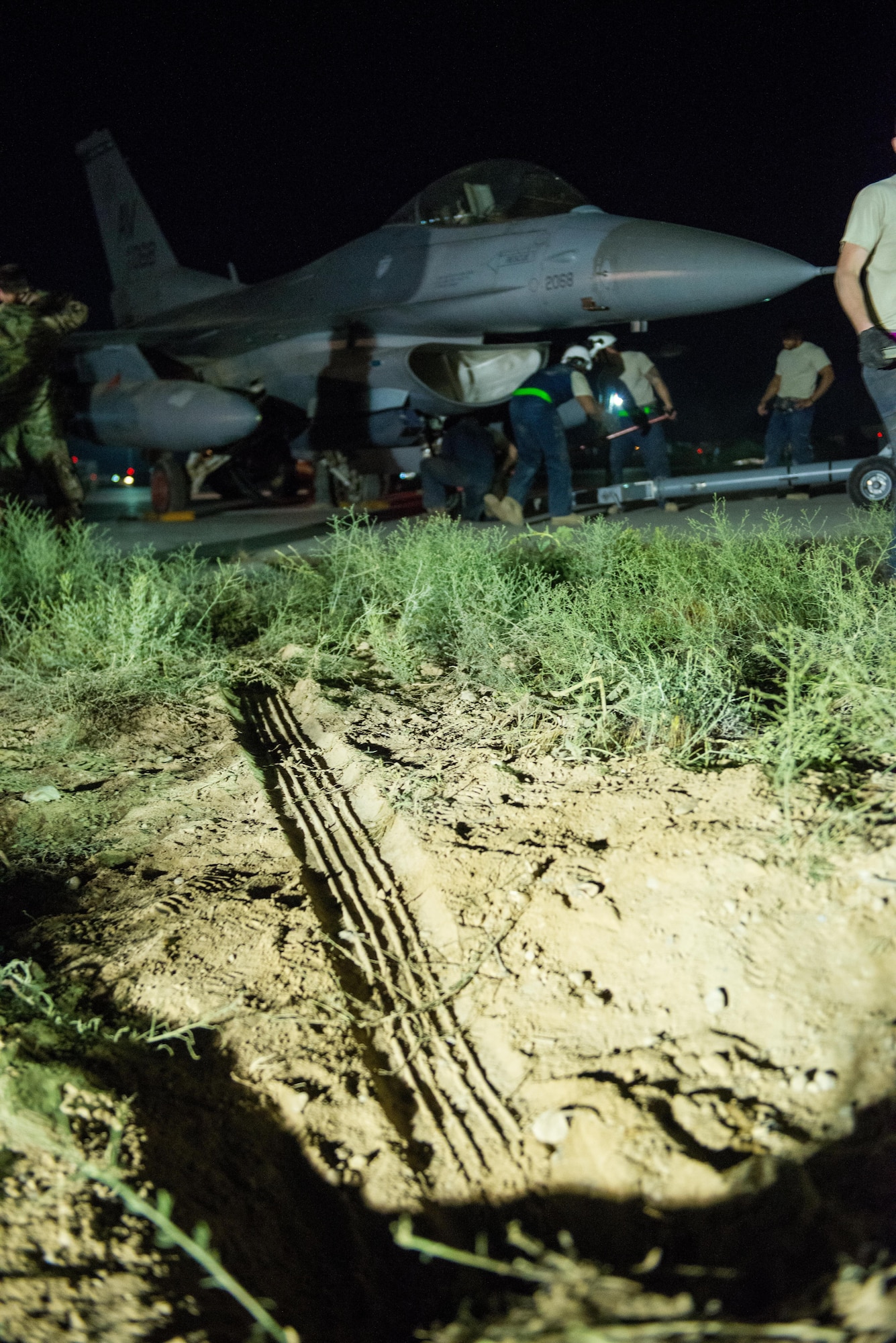 U.S. Airmen assigned to the 455th Expeditionary Aircraft Maintenance Squadron move an F-16 Fighting Falcon aircraft that had departed the runway while landing at Bagram Air Field, Afghanistan, May 4, 2015. The 455th EAMXS maintainers were able to expeditiously recover the aircraft and return the runway to operational status; the pilot was uninjured while the F-16 only sustained minor damage in the mishap.  (U.S. Air Force photo by Tech. Sgt. Joseph Swafford/Released)