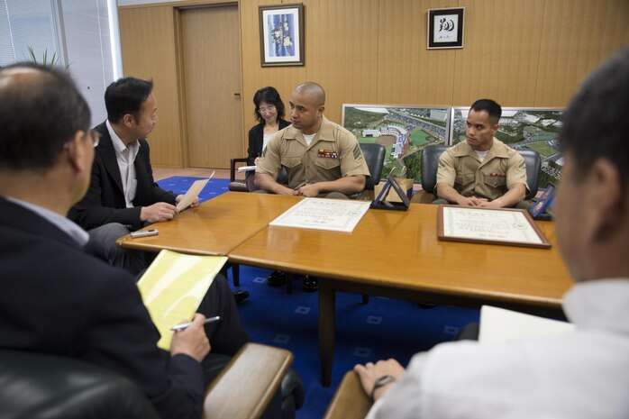 Yoshihiko Fukuda, mayor of Iwakuni City, converses with representatives from Headquarters and Headquarters Squadron and Marine Aerial Transport Refueler Squadron 152 aboard Marine Corps Air Station Iwakuni, Japan, during their meeting at city hall June 3, 2015. The representatives went to city hall to report to the mayor after receiving awards from the Japan Good Deeds Association during their 65th Spring Commendation Ceremony in May. H&HS and VMGR-152 received the awards for assisting the local community whose homes were affected by a mudslide in August 2014.