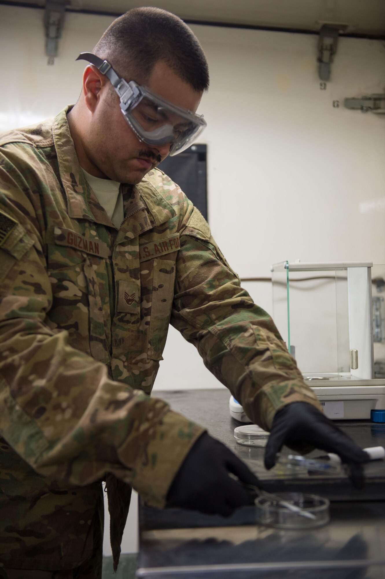 U.S. Air Force Staff Sgt. Joseph Guzman, 455th Expeditionary Logistics Readiness Squadron Fuels Laboratory noncommissioned officer in charge, conducts a fuel sample analysis at Bagram Air Field, Afghanistan, May 16, 2015. Guzman ensures the fuel delivered to aircraft at Bagram meets the Air Force standard. (U.S. Air Force photo by Tech Sgt. Joseph Swafford/Released)