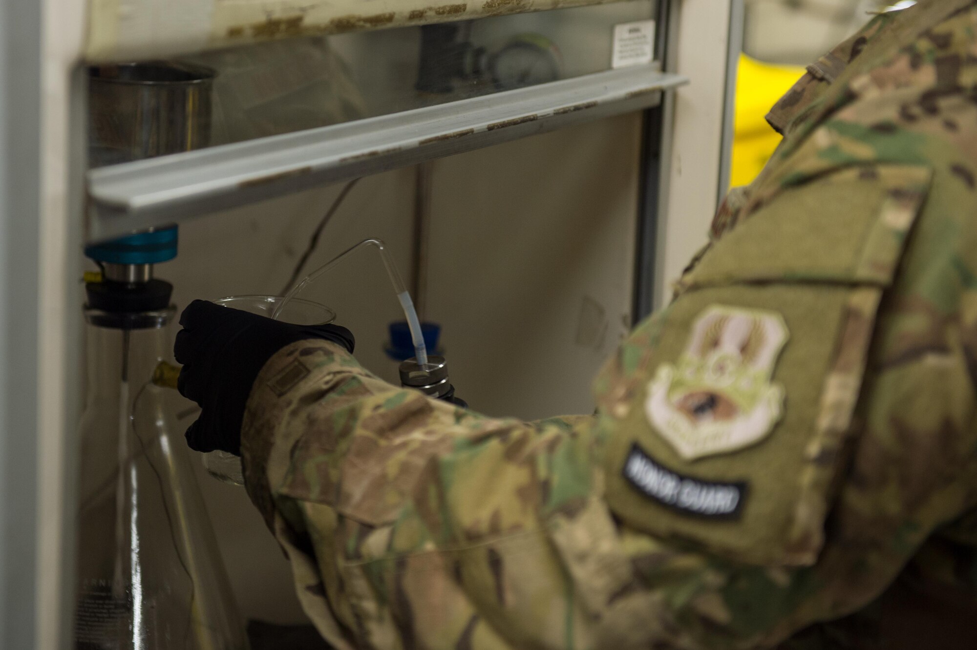 U.S. Air Force Staff Sgt. Joseph Guzman, 455th Expeditionary Logistics Readiness Squadron Fuels Laboratory noncommissioned officer in charge, conducts a fuel sample analysis at Bagram Air Field, Afghanistan, May 16, 2015. Guzman ensures the fuel delivered to aircraft at Bagram meets the Air Force standard. (U.S. Air Force photo by Tech Sgt. Joseph Swafford/Released)
