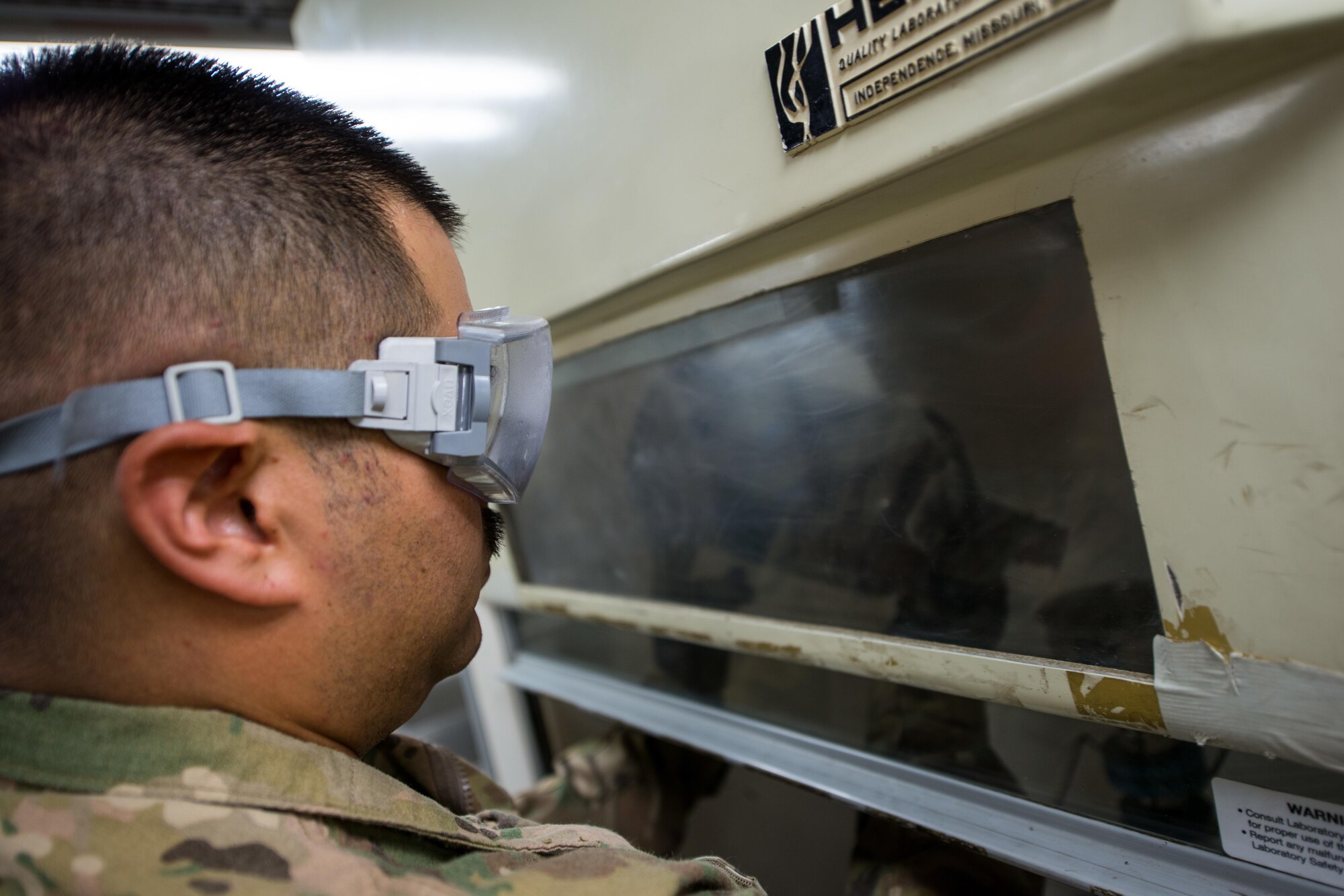U.S. Air Force Staff Sgt. Joseph Guzman, 455th Expeditionary Logistics Readiness Squadron Fuels Laboratory noncommissioned officer in charge, conducts a fuel sample analysis at Bagram Air Field, Afghanistan, May 16, 2015. Guzman ensures the fuel delivered to aircraft at Bagram meets the Air Force standard. (U.S. Air Force photo by Tech Sgt. Joseph Swafford/Released)