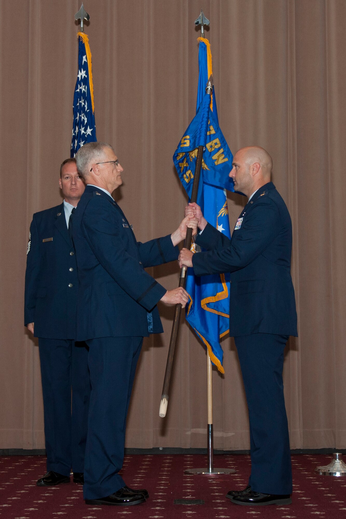 U.S. Air Force Maj. Brian Plauche (right) takes grip of the 307th Aircraft Maintenance Squadron guidon during an Assumption of Command Ceremony, June 6, 2015, Barksdale Air Force Base, La. Plauche is the former Operations Officer for the 707th Maintenance Squadron. (U.S. Air Force photo by Master Sgt. Dachelle Melville/Released)