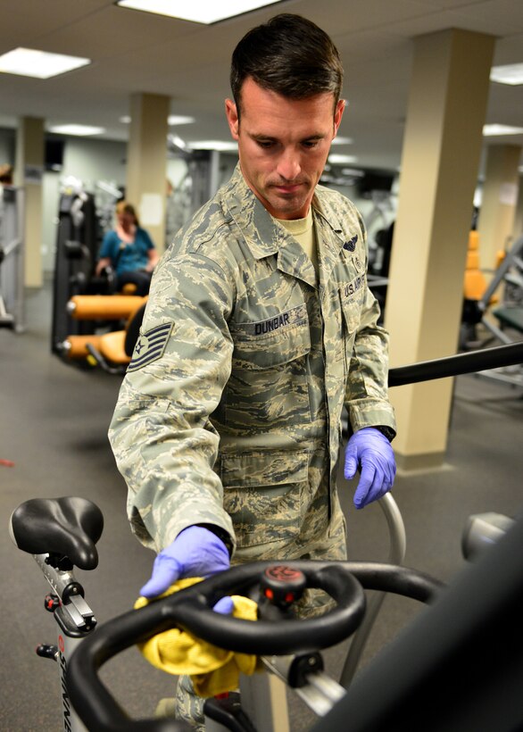 Tech. Sgt. Eli Dunbar, 919th Special Operations Medical Squadron, wipes down equipment during the G. I. party June 7 at Duke Field, Fla. A group of Airmen from the 919th SOMDS came together to clean the fitness center during the June unit training assembly. (U.S. Air Force photo/ Tech. Sgt. Cheryl L. Foster)