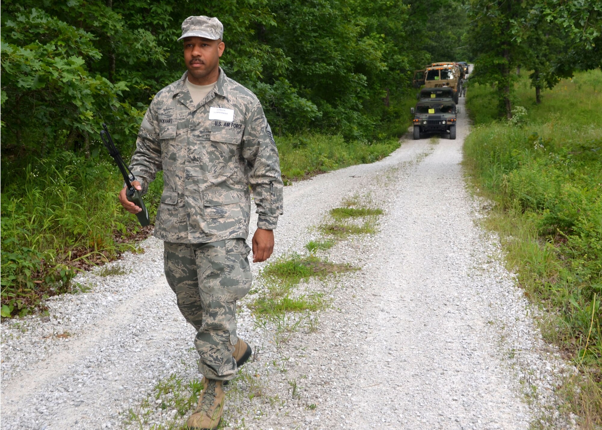 Master Sgt. Ervin Lockhart, a radio frequency technician with the 239th Combat Communications Squadron, directs his team as they move simulated barriers out of their path.  Lockhart served as the convoy and incident commander during a mass casualty exercise at Camp Clark, Missouri, June 4, 2015.  