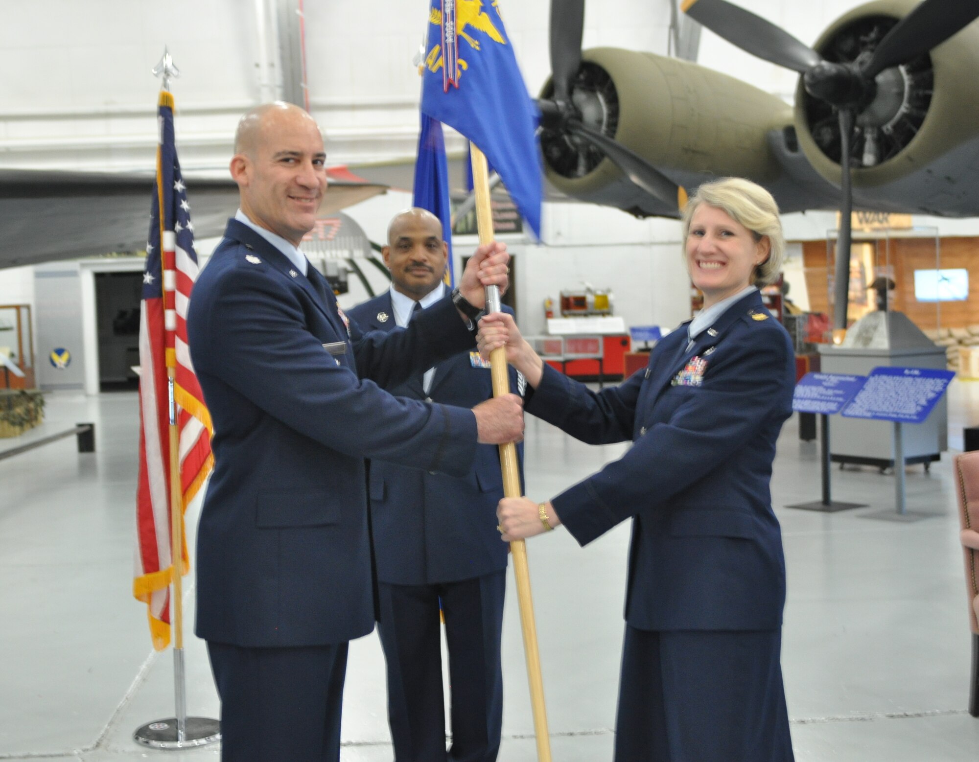 Maj. Dori Mansur (right) accepts the 46th Aerial Port Squadron guidon from Lt. Col. Bruce A. Carper (left), 512th Mission Support Group commander, June 7, 2015 at the Air Mobility Command Museum, Dover, Del. Mansur joins the 512th Airlift Wing after having served as operations officer of the 514th Logistics Readiness Squadron, Joint Base McGuire-Lakehurst-Dix, New Jersey. (U.S. Air Force photo/Senior Airman Joe Yanik) 