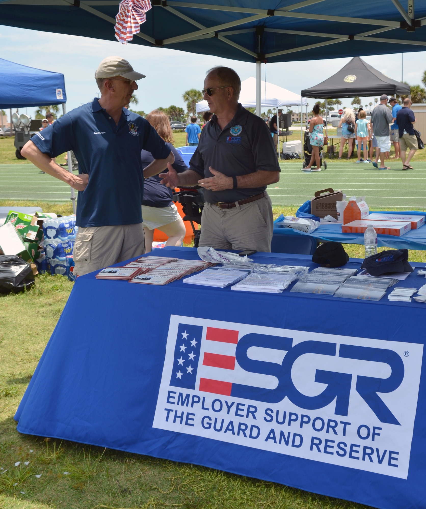 Col. Jeffrey Macrander (right), 920th Rescue Wing commander, talks with retired Army Lt. Col. Roger Trout, Employer Support of the Guard and Reserve ombudsman, at the 920th RQW Family Day picnic at Patrick Air Force Base, Fla., June 6, 2015. The Florida ESGR Committee has five full-time volunteers dedicated to helping Reservists and Guardsmen and their civilian employers with military-related issues. (U.S. Air Force photo by 2nd Lt. Anna-Marie Wyant) 