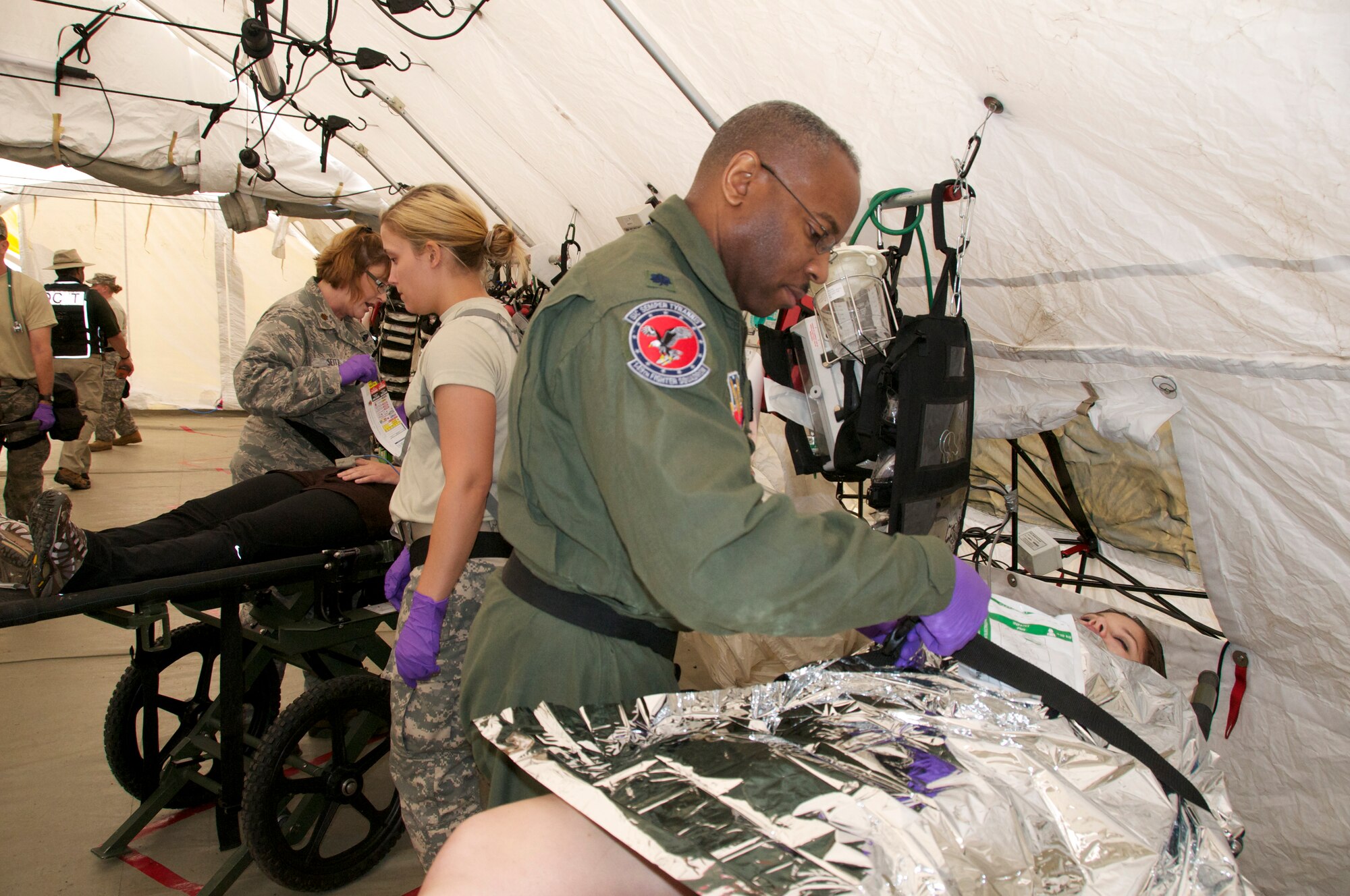 More than 45 airmen assigned to the Virginia Army and Air National Guard participated a six-day external evaluation involving scenarios that tested their Chemical, Biological, Radiological, Nuclear, and Explosive (CBRNE) Enhanced Response Force Package (CERFP) skills, May 11-16 at the Virginia Beach Fire and EMS Training Center in Virginia Beach, Virginia.  Members from the 192nd Fighter Wing Medical Group were required to perform medical triage by taking patients out of decontamination and examining them to determine how they should be medically treated. (U.S. Air National Guard photo by Master Sgt. Carlos J. Claudio/Released)
