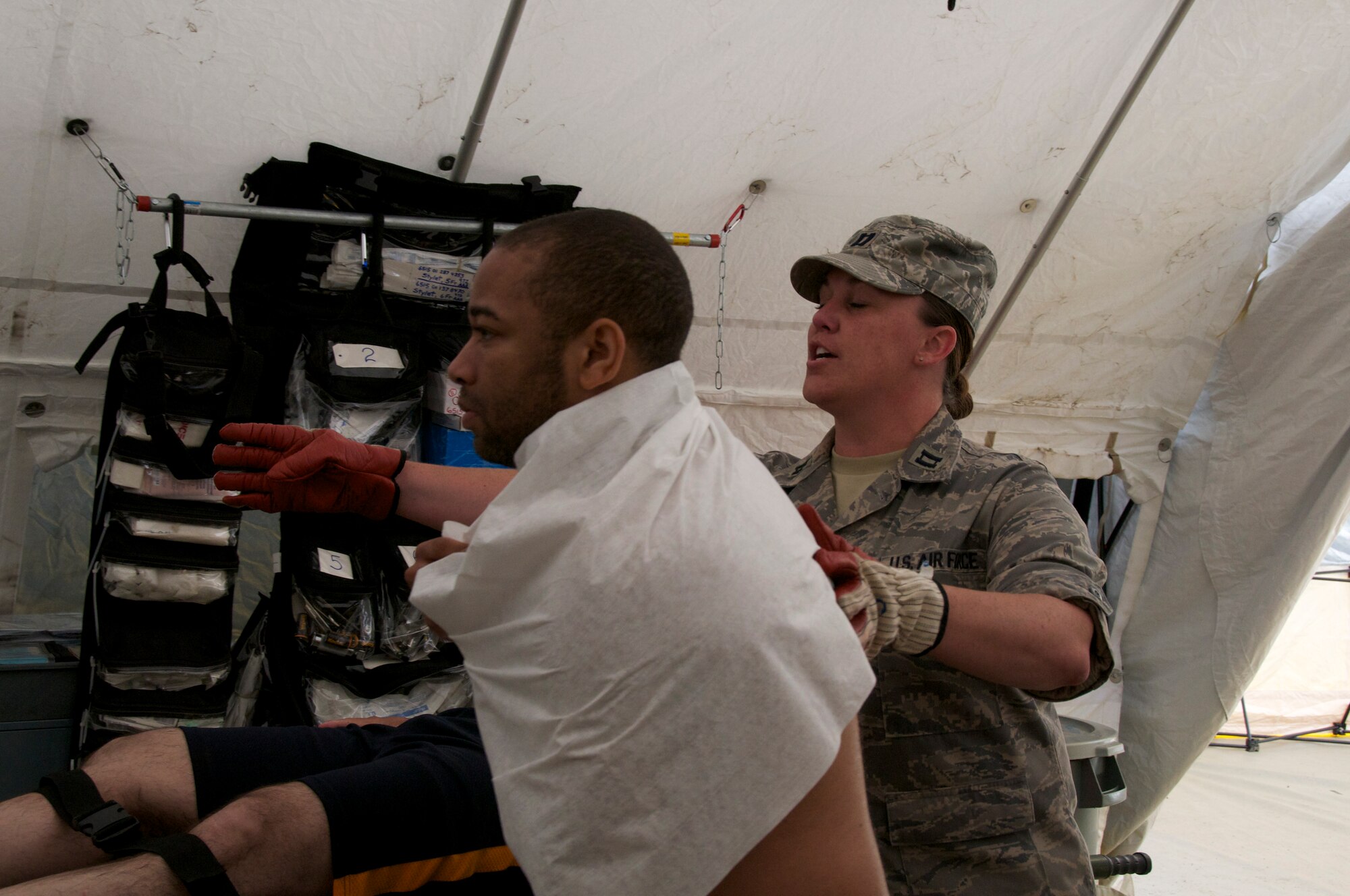 More than 45 airmen assigned to the Virginia Army and Air National Guard participated a six-day external evaluation involving scenarios that tested their Chemical, Biological, Radiological, Nuclear, and Explosive (CBRNE) Enhanced Response Force Package (CERFP) skills, May 11-16 at the Virginia Beach Fire and EMS Training Center in Virginia Beach, Virginia.  Members from the 192nd Fighter Wing Medical Group were required to perform medical triage by taking patients out of decontamination and examining them to determine how they should be medically treated. (U.S. Air National Guard photo by Master Sgt. Carlos J. Claudio/Released)
