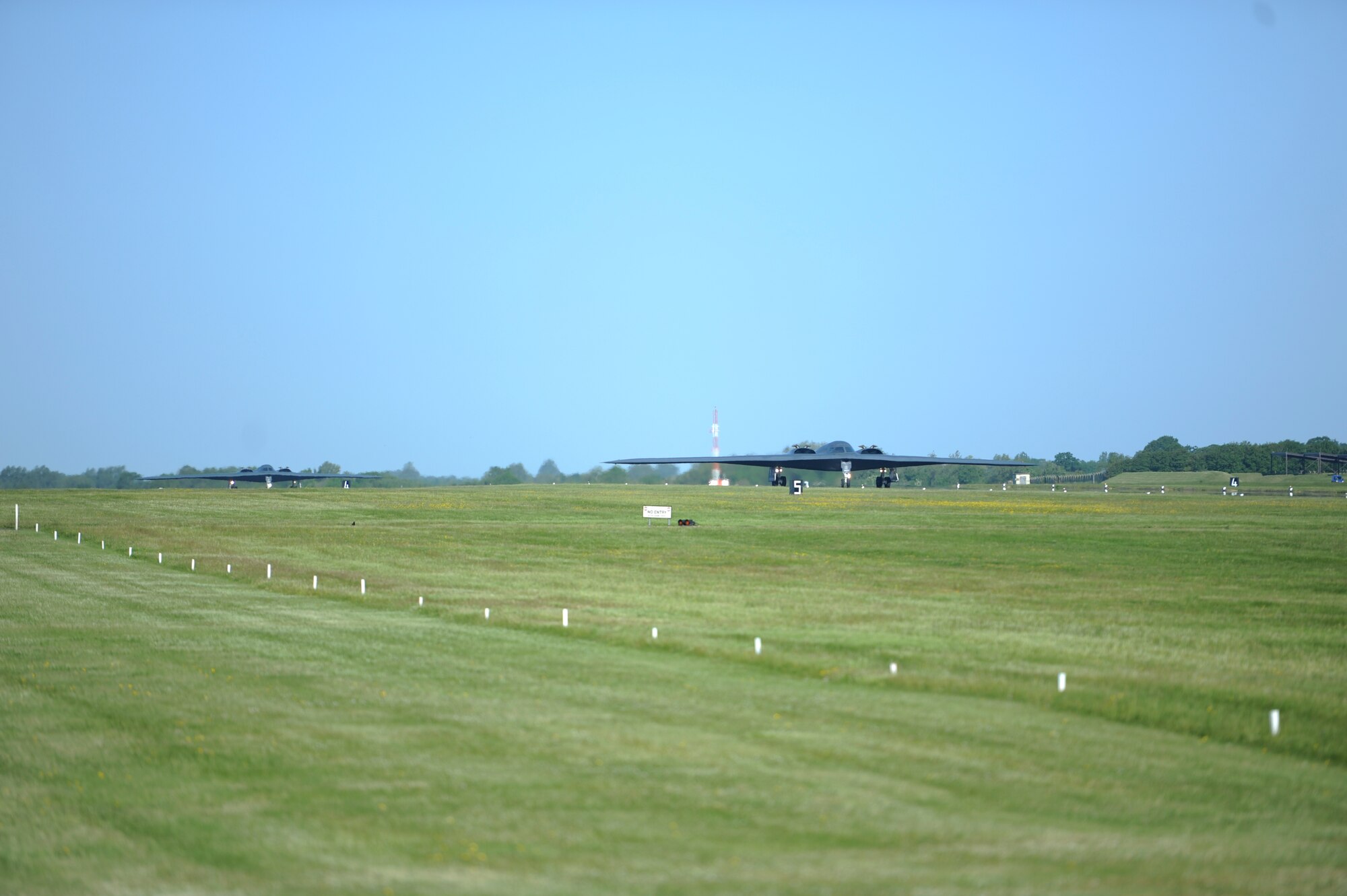 Two B-2 Spirits taxi to a hot-pit refueling and engine running crew change after landing at Royal Air Force Fairford, England, June 7, 2015. The two aircraft traveled from Whiteman Air Force Base to RAF Fairford, England, an installation capable of supporting the aircraft and these vital activities due to its forward location and infrastructure. (U.S. Air Force photo/Capt. Christopher Mesnard)