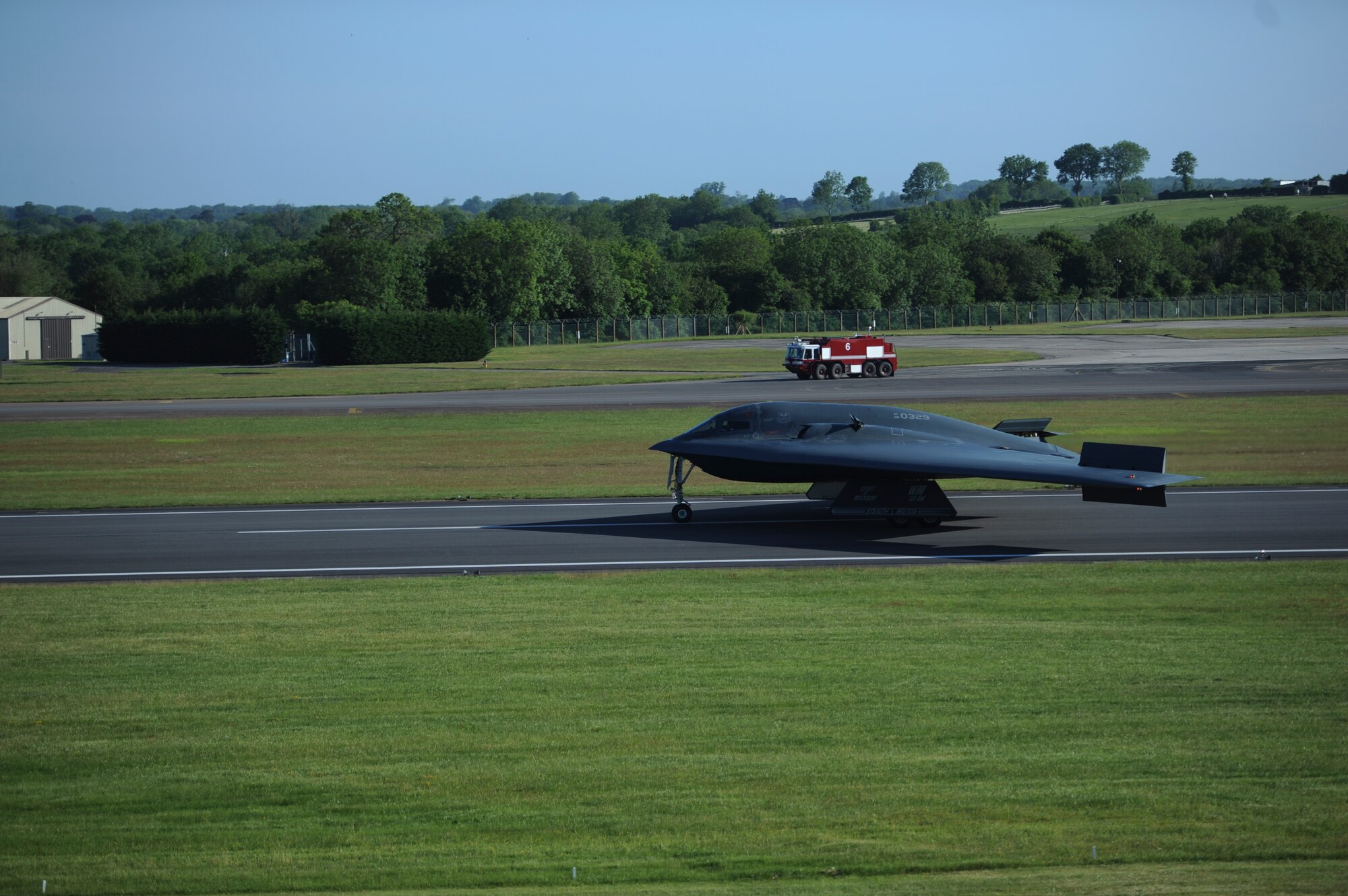 A B-2 Spirit lands at Royal Air Force Fairford, England, June 7, 2015. The 509th and 131st Bomb Wing crew chiefs and aircrews conducted a hot-pit refueling and engine running crew change on the B-2 Spirit while it was at RAF Fairford to test the valuable skills of refueling the aircraft and changing air crew in a forward deployed location. (U.S. Air Force photo/Capt. Christopher Mesnard)