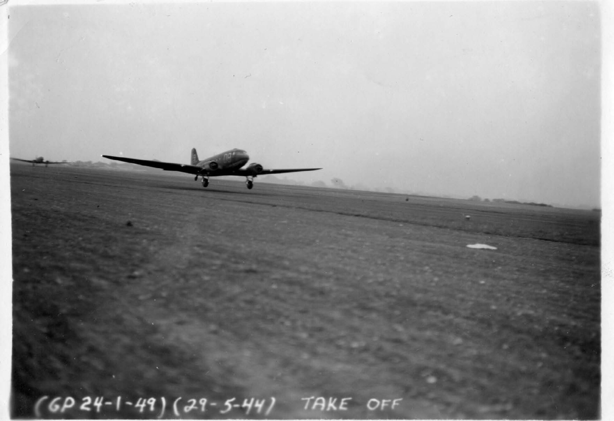 A C-47 Skytrain with the tail number 857, takes off from Upottery Airfield, in East Devon, England, May 29, 1944. At this point, it had not received its invasion strips. The “D8” on the fuselage tells that it was a plane assigned to the 94th Troop Carrier Squadron. The “B” on the tail is its individual marker. This aircraft is now a static display of the 176th Wing on JBER, Alaska.