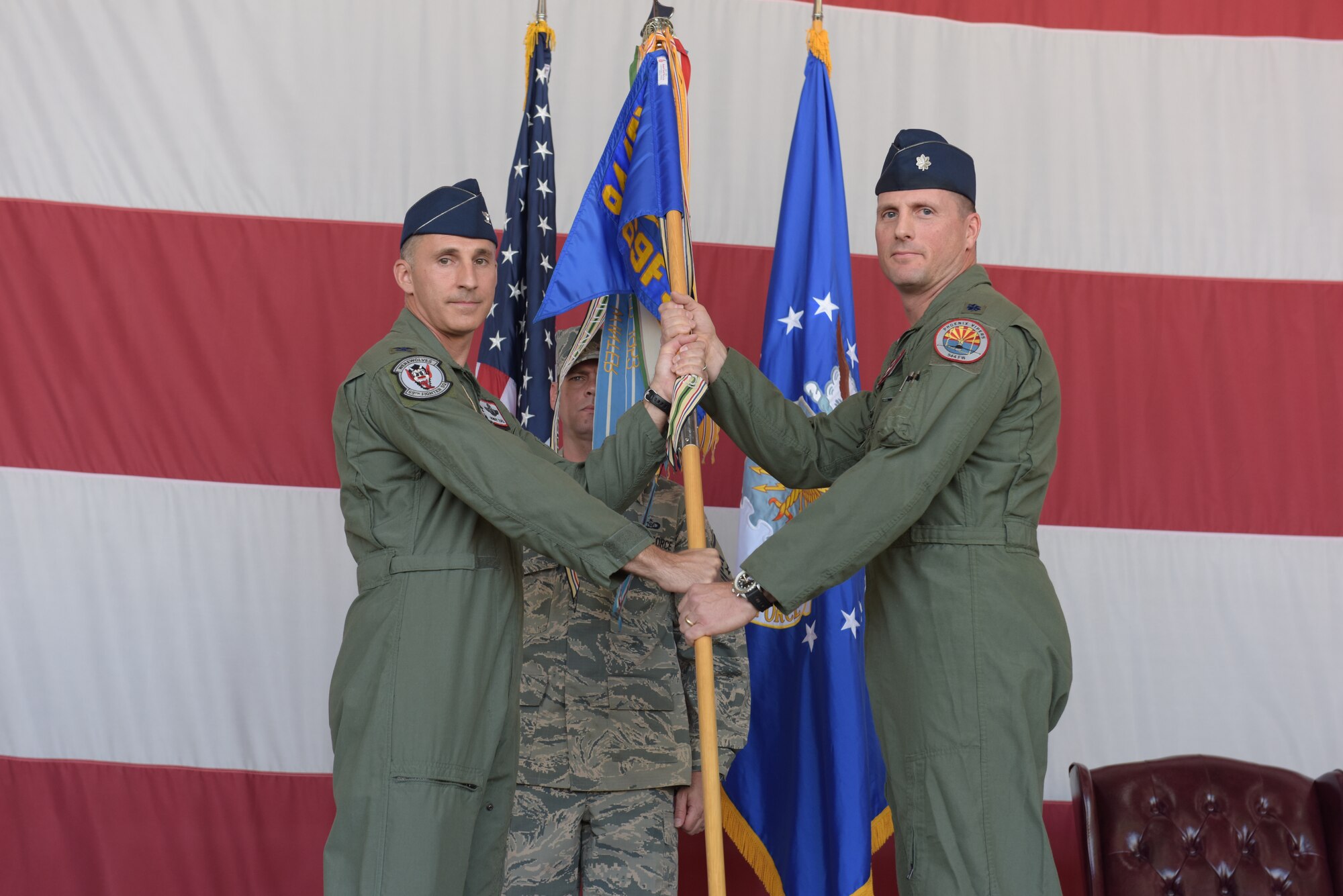 U.S. Air Force Col. Robert Tofil, 944th Operations Group commander, welcomes the new 69th Fighter Squadron commander, Lt. Col. Saxon Yandell at the change of command ceremony, Luke Air Force Base, Ariz, June 4. Yandell assumed command in place of Lt. Col. Korey Amundson, 69th Fighter Squadron prior commander.(U.S. Air Force Staff Sgt. Lausanne Kinder/Released)
