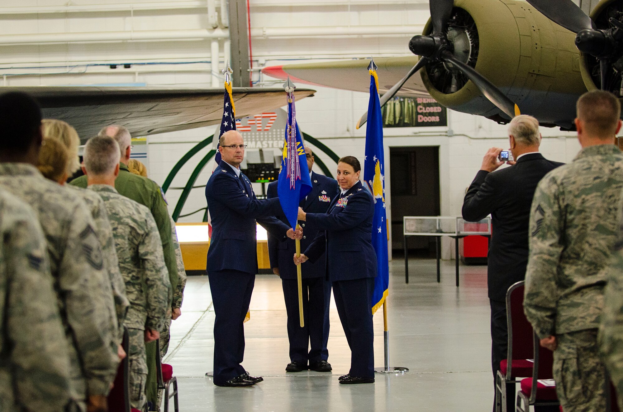 Col. Raymond Kozak, 512th Airlift Wing commander, presents Lt. Col. Laura Radley, 512th Mission Support Group commander, with the 512th MSG guidon during an assumption of command ceremony, June 6, 2015, at the Air Mobility Command museum, Dover Air Force Base, Del. Assumptions of command are a military tradition to representing the transfer of responsibilities from the presiding officials to the incoming commander. (U.S. Air Force photo/Capt. Bernie Kale)