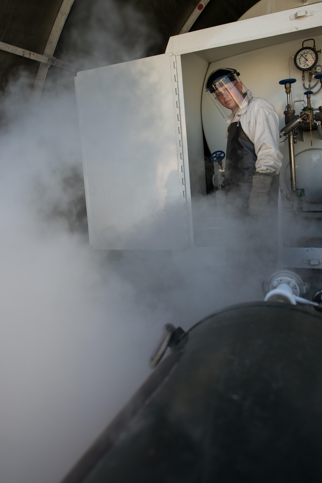 U.S. Air Force Staff Sgt. Mykel Wilson, 455th Expeditionary Logistics Readiness Squadron cryogenics shop noncommissioned officer in charge deployed from Kadena Air Base, Japan, fills 50-gallon liquid oxygen (LOX) carts at Bagram Air Field, Afghanistan, May 16, 2015. The cryogenics shop is responsible for supplying, storing and making sure the LOX used at Bagram meets Air Force standards. (U.S. Air Force photo by Tech. Sgt. Joseph Swafford/Released)