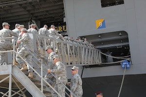 On May 15, approximately 50 personnel from the Joint Enabling Capabilities Command (JECC) Army Reserve Element (ARE) file onboard the USS George H.W. Bush (CVN-77) during their tour of the Nimitz-class aircraft carrier at Naval Station Norfolk, Va. Following the unique tour, the JECC ARE personnel have a better understanding of the Service-specific capabilities the U.S. Navy brings to joint operational requirements.