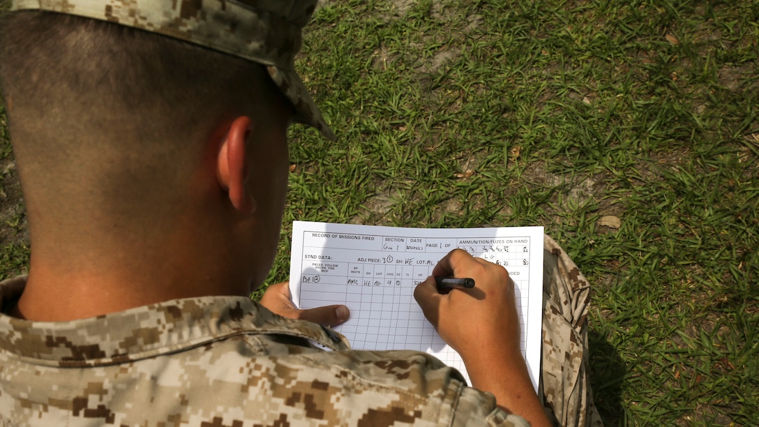 A Marine with 1st Battalion, 10th Marine Regiment fills out a record of mission fired data sheet during a section chief course at Marine Corps Base Camp Lejeune, N.C., May 28, 2015. During the practical application fire missions, given to them by their instructors, the Marines had to keep record of shots fired from the howitzer.