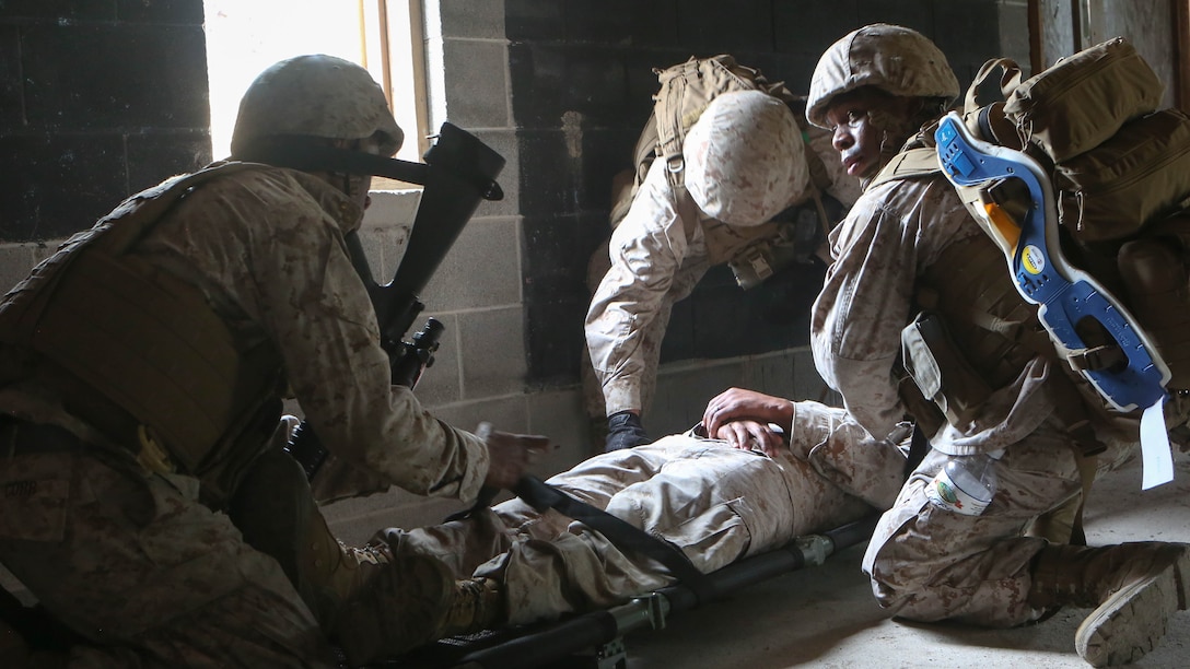 U.S. Marines and a Navy corpsman with Combat Logistics Battalion 26, 26th Marine Expeditionary Unit, provide first aid to a simulated patient during a mass casualty training exercise at Combat Town aboard Marine Corps Base Camp Lejeune, N.C., June 3, 2015. Marines and sailors with CLB 26 performed casualty assessment, applied first aid and transported the simulated casualties to a landing zone. The training was conducted to prepare for the 26th MEU's deployment to the 5th and 6th Fleet areas of responsibility later this year. 