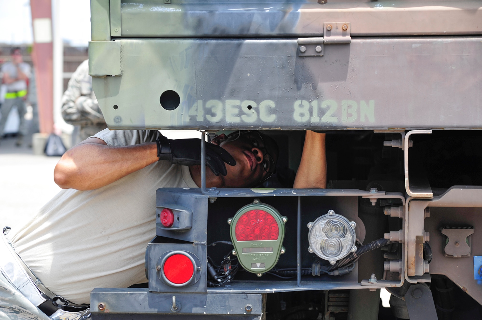 Tech. Sgt. Jerone Mack, an Air Terminal Operations Center and Special Handling team member assigned to the 38th Aerial Port Squadron at Joint Base Charleston, S.C., inspects the underside of a cargo vehicle in preparation for the mini-Port Dawg Challenge held here during the unit training assembly weekend June 6, 2015. Airmen from the 38 and 81 APS will go on to compete with aerial port squadrons from across the country later this month in the annual Port Dawg Challenge for the honor of being the “Top Dawgs” among their peers. (U.S. Air Force photo by Staff Sgt. Bobby Pilch)