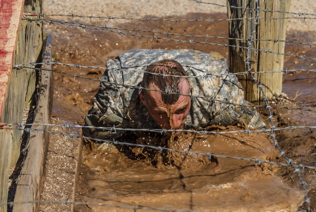 Army Reserve drill sergeant, Staff Sgt. Russell Vidler, 98th Training Division (IET), negotiates the mud obstacle during the third day of competition at the 108th Training Command (IET) combined Best Warrior and Drill Sergeant of the Year competition held at Fort Huachuca, Ariz. Vidler is one of five drill sergeants competing for the top honor in this year's competition. (U.S. Army photo by Sgt. 1st Class Brian Hamilton)