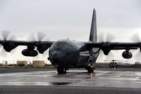 A C-130H Hercules from the Wyoming Air National Guard taxis to its parking spot as an HH-60 Pave Hawk waits during an Angel Thunder 2015 mass casualty exercise at Winslow-Lindbergh Regional Airport, Ariz., June 5, 2015. The C-130H transported medical equipment, service members and students from the University of Arizona and Northern Arizona University to the training locations in northern Arizona. (U.S. Air Force photo/Tech. Sgt. Courtney Richardson)