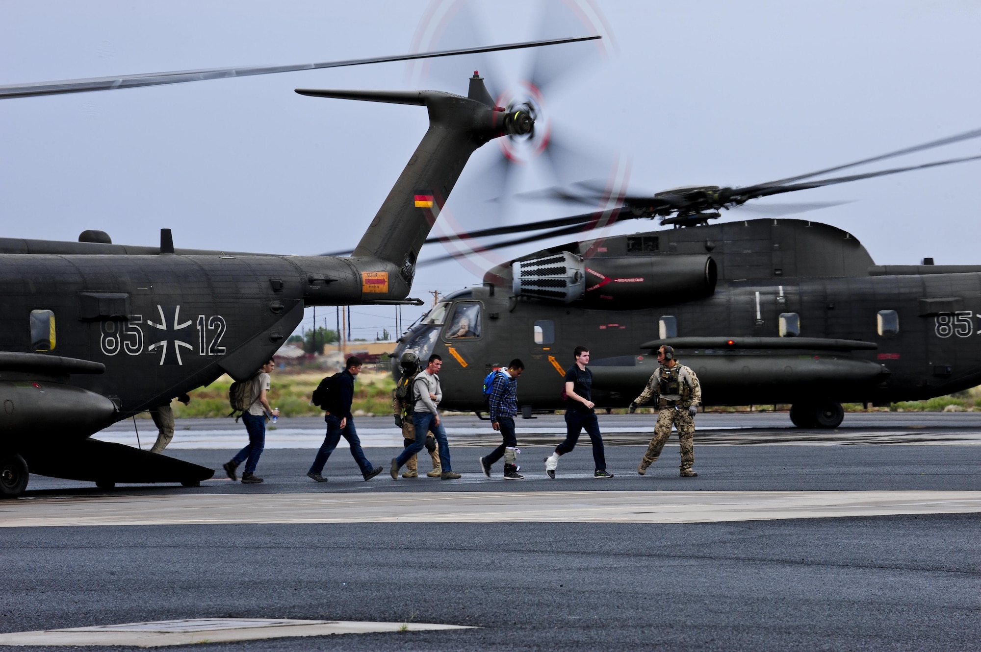 German air force rescue personnel lead simulated patients off of a German army CH-53GS during an Angel Thunder 2015 mass casualty exercise at Winslow-Lindbergh Regional Airport, Ariz., June 5, 2015. U.S. military forces and partner nations worked together during the exercise to transport patients from Camp Navajo Training Site, Ariz., to the casualty collection point located at the Winslow–Lindbergh Regional Airport. (U.S. Air Force photo/Airman 1st Class Chris Drzazgowski)
