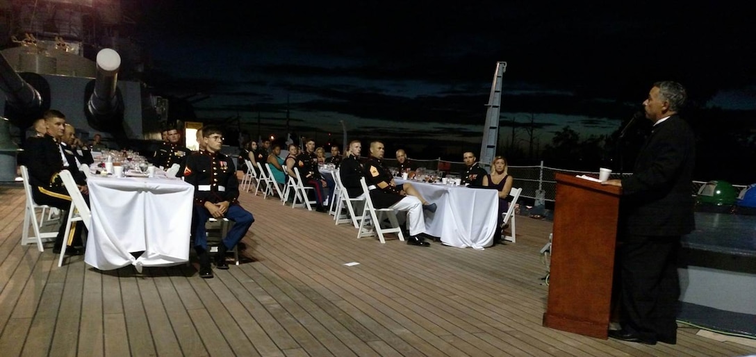 29 May 2015 – Weapons Training Battalion Marines and their guests listen to guest of honor John Ligato during a Dining In aboard the USS North Carolina.  A decorated Marine, retired FBI Special Agent, and author, Mr. Ligato shared his experiences as part of the first Marine contingent to enter Hue City, Vietnam in 1968.