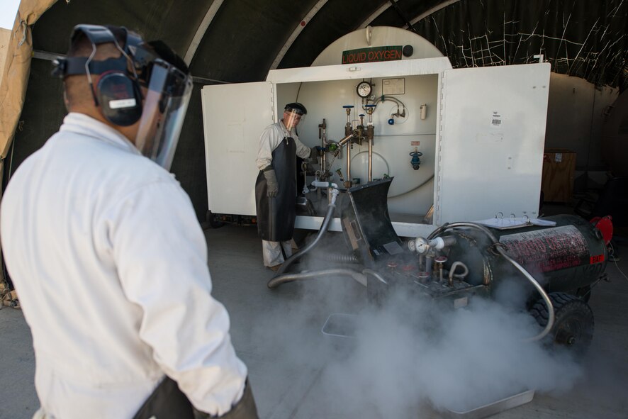 U.S. Air Force Staff Sgt. Mykel Wilson, 455th Expeditionary Logistics Readiness Squadron cryogenics shop noncommissioned officer in charge deployed from Kadena Air Base, Japan, fills a 50-gallon liquid oxygen (LOX) cart at Bagram Air Field, Afghanistan, May 16, 2015. The cryogenics shop is responsible for supplying, storing and making sure the LOX used at Bagram meets Air Force standards. (U.S. Air Force photo by Tech Sgt. Joseph Swafford/Released)