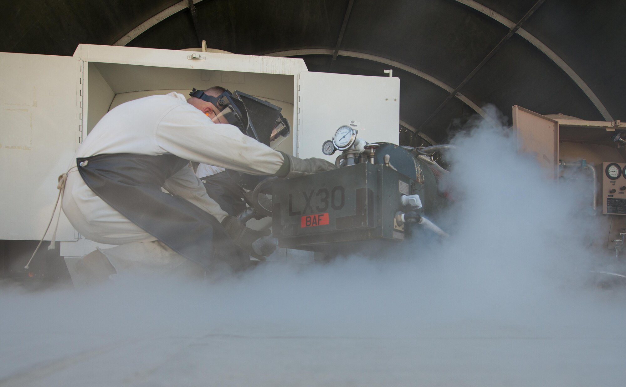 U.S. Air Force Staff Sgt. Mykel Wilson, 455th Expeditionary Logistics Readiness Squadron cryogenics shop noncommissioned officer in charge deployed from Kadena Air Base, Japan, takes a quality-testing sample from a 50-gallon liquid oxygen (LOX) cart at Bagram Air Field, Afghanistan, May 16, 2015. The cryogenics shop is responsible for supplying, storing and making sure the LOX used at Bagram meets Air Force standards. (U.S. Air Force photo by Tech Sgt. Joseph Swafford/Released)