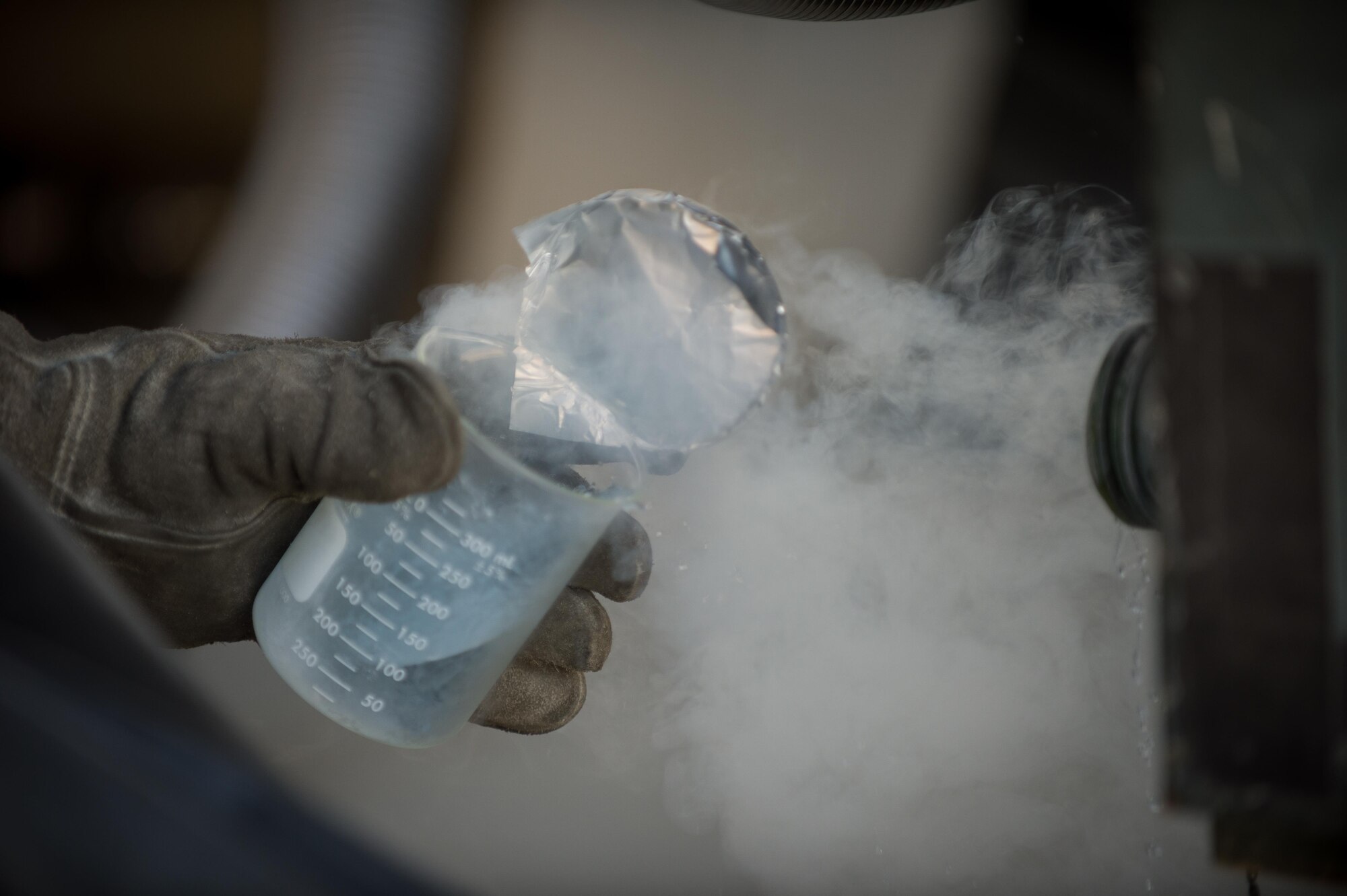 U.S. Air Force Staff Sgt. Mykel Wilson, 455th Expeditionary Logistics Readiness Squadron cryogenics shop noncommissioned officer in charge deployed from Kadena Air Base, Japan, takes a quality-testing sample from a 50-gallon liquid oxygen (LOX) cart at Bagram Air Field, Afghanistan, May 16, 2015. The cryogenics shop is responsible for supplying, storing and making sure the LOX used at Bagram meets Air Force standards. (U.S. Air Force photo by Tech Sgt. Joseph Swafford/Released)