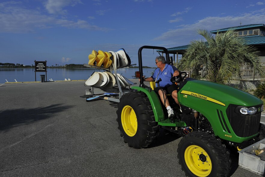 Raymond Stichler, Outdoor Recreation recreational aid, brings stand-up paddle boards and kayaks out of storage for the day at Hurlburt Field, Fla., June 4, 2015. The Outdoor Recreation SUP class is new to Hurlburt Field this year and classes are held Tuesdays and Thursdays from 7:30 a.m. to 8:30 a.m. weekly at the Sound Side. (U.S. Air Force photo/Airman Kai White)