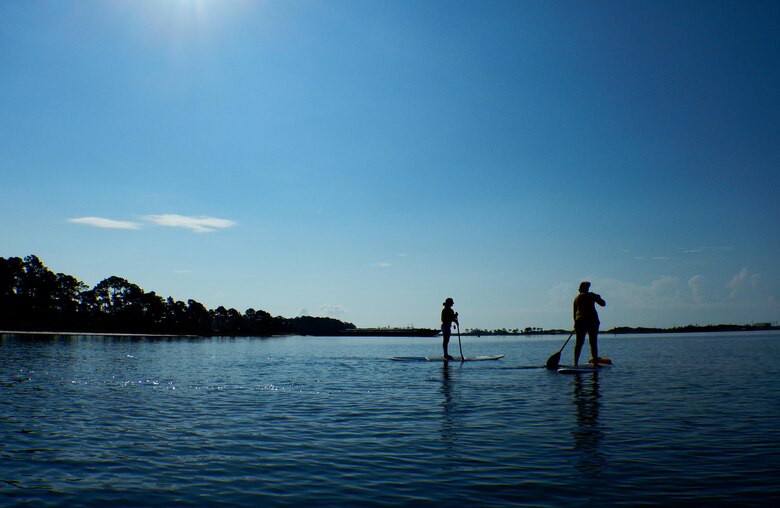 Stand-up paddle boarding class attendees paddle in the Santa Rosa Sound at Hurlburt Field, Fla., June 4, 2015. The Outdoor Recreation SUP class is new to Hurlburt Field this year and classes are held Tuesdays and Thursdays from 7:30 a.m. to 8:30 a.m. weekly at the Sound Side. (U.S. Air Force photo/Airman Kai White)