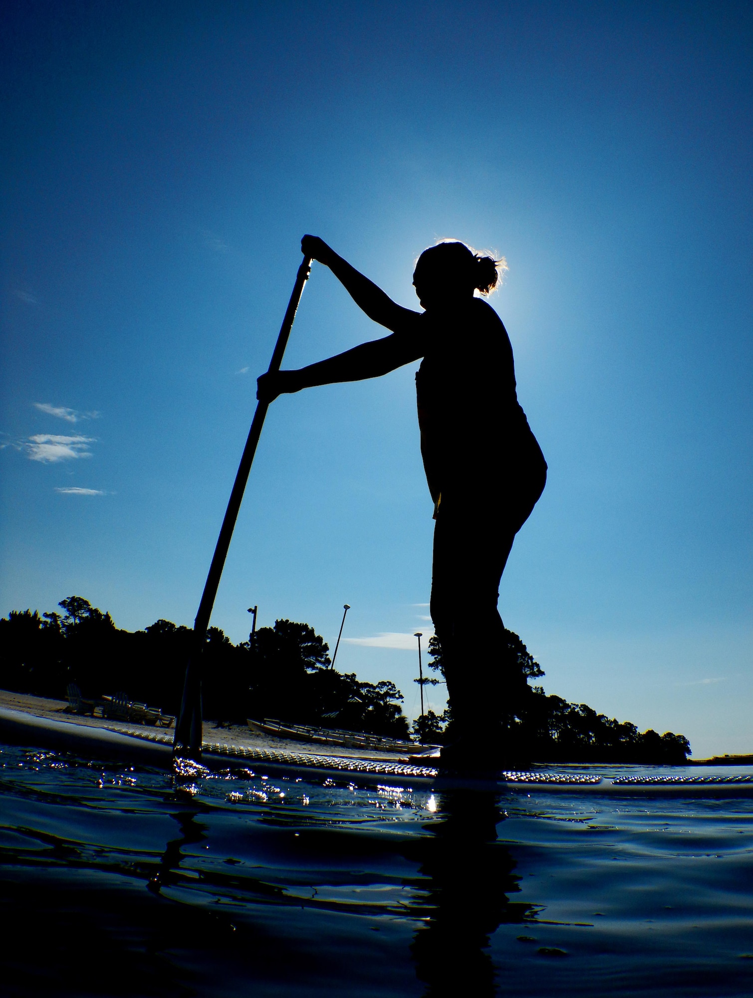 Kirsten J. Nunweiler, an Outdoor Recreation operations assistant, demonstrates a paddling stroke during a stand-up paddle boarding class at the Hulburt Field Sound Side, Fla., June 4, 2015. The Outdoor Recreation SUP class is new to Hurlburt Field this year and classes are held Tuesdays and Thursdays from 7:30 a.m. to 8:30 a.m. weekly at the Sound Side. (U.S. Air Force Photo/Airman Kai White)