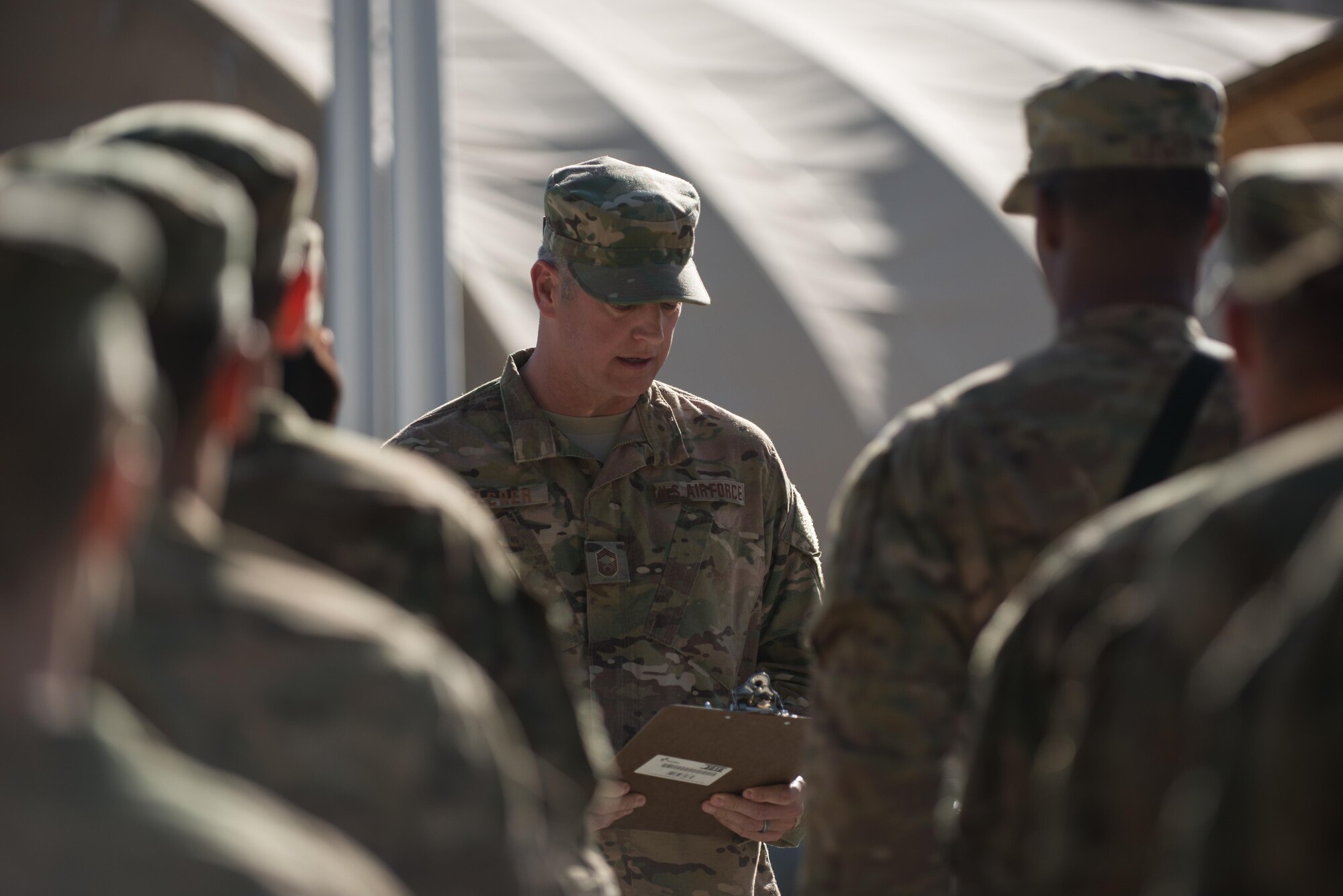 U.S. Air Force Chief Master Sgt. David Belcher, 455th Expeditionary Mission Support Group command chief, conducts the final role call during the remembrance ceremony and retreat at Bagram Air Field, Afghanistan, May 26, 2015. Service members at Bagram gathered during the ceremony to remember those who gave their lives while deployed to Afghanistan. (U.S. Air Force photo by Tech. Sgt. Joseph Swafford/Released)