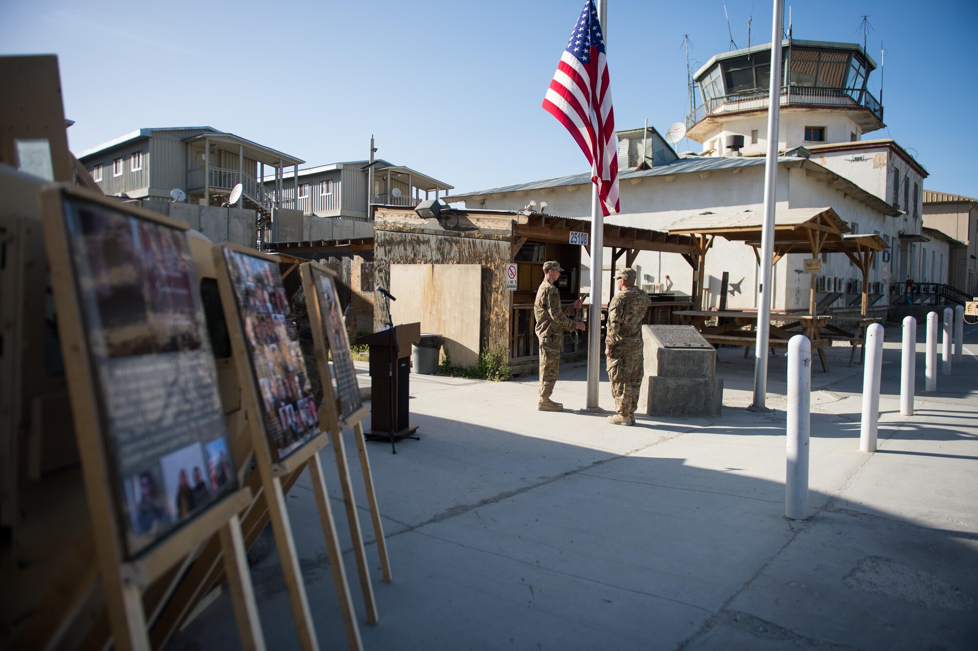 U.S. Air Force Tech. Sgt. Jose Rios, right, and Senior Airman Remi Follette, both with the Bagram Air Field (BAF) honor guard, lower the U.S. flag during a remembrance ceremony and retreat in Afghanistan, May 26, 2015. Service members at BAF gathered during the ceremony to remember those who gave their lives while deployed to Afghanistan. (U.S. Air Force photo by Tech. Sgt. Joseph Swafford/Released)