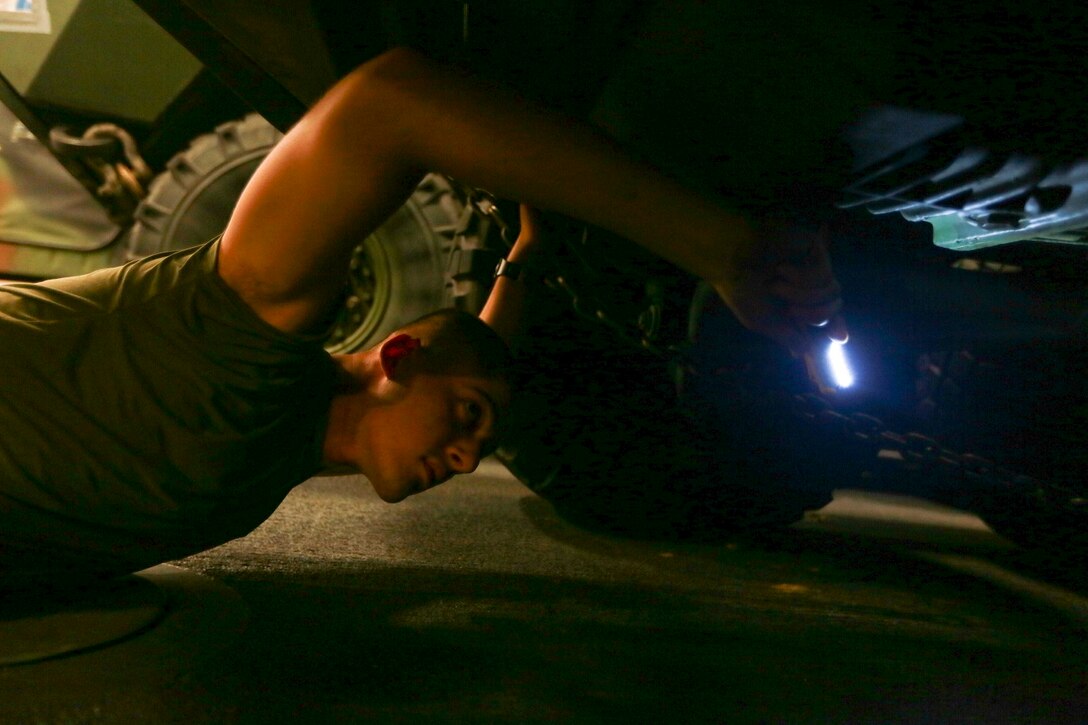 U.S. Marine Lance Cpl. Ivan Orozco checks for rust on a Light Armored Vehicle (LAV-25) aboard the USS Anchorage (LPD 23) in the Philippine Sea, June 5, 2015. Orozco is an LAV crewman with 1st Light Armored Reconnaissance Battalion, 15th Marine Expeditionary Unit. The Marines and Sailors of the 15th MEU constantly perform maintenance on their equipment to maintain combat readiness. (U.S. Marine Corps photo by Sgt. Jamean Berry/Released)