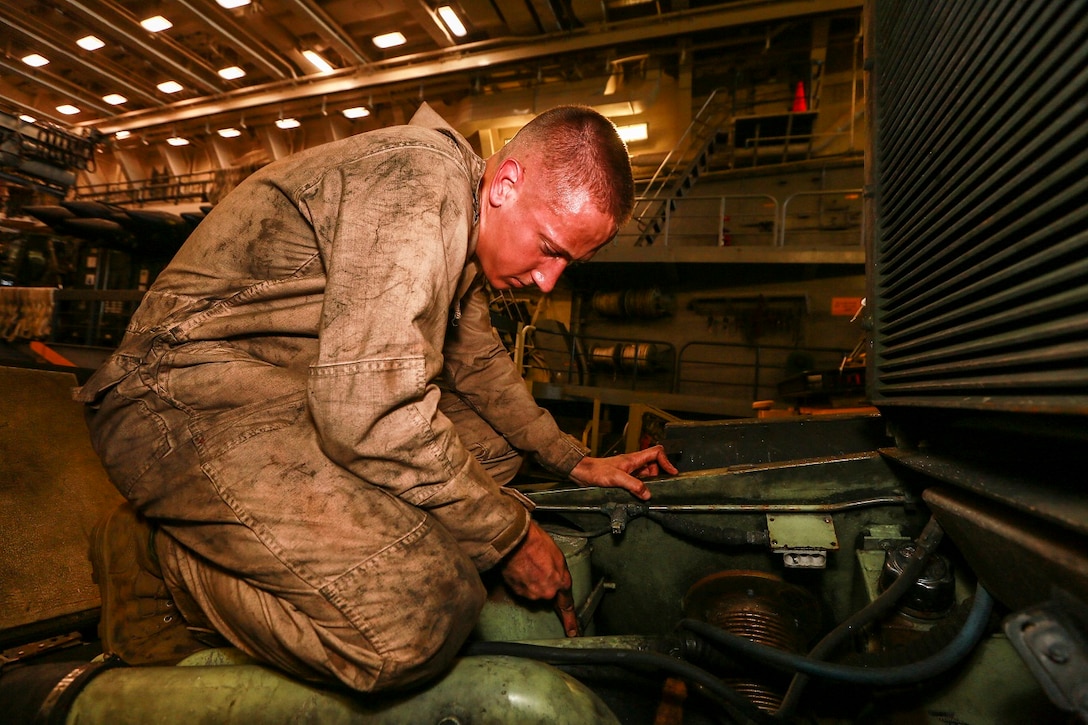 U.S. Marine Lance Cpl. Shane Ledbetter performs vehicle maintenance on a Light Armored Vehicle (LAV-25) aboard the USS Anchorage (LPD 23) in the Philippine Sea, June 5, 2015. Ledbetter is an LAV crewman with 1st Light Armored Reconnaissance Battalion, 15th Marine Expeditionary Unit. The Marines and Sailors of the 15th MEU constantly perform maintenance on their equipment to maintain combat readiness. (U.S. Marine Corps photo by Sgt. Jamean Berry/ Released)
