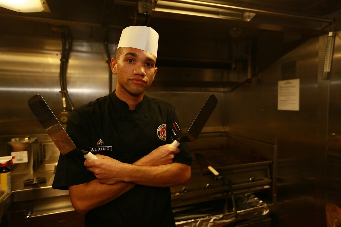 U.S. Marine Cpl. Julio Albino is a Food Service Specialist with the 15th Marine Expeditionary Unit aboard the USS Anchorage (LPD 23) in the Philippine Sea, June 6, 2015. Albino holds the billet of assistant chief cook. The duties of a chief cook include quality control, instructing junior food service specialists on new techniques, and how to cook new recipes creating better products for the crew and personnel aboard the USS Anchorage. The assistant chief cook is also responsible for ensuring all food cooked in the mess deck is held to a high standard. (U.S. Marine Corps photo by Sgt. Jamean Berry/ Released)