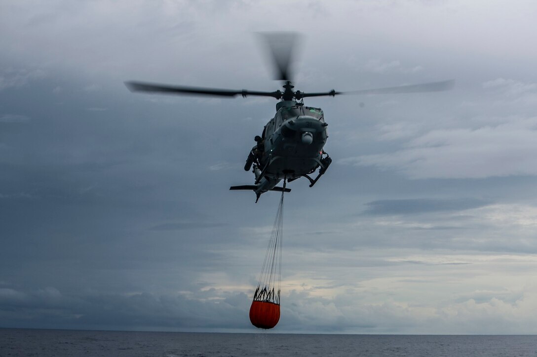 A U.S. Marine UH-1Y Venom with Marine Medium Tiltrotor Squadron 161 (Reinforced), 15th Marine Expeditionary Unit, prepares to land with a Bambi Bucket on the USS Anchorage (LPD 23) in the Philippine Sea, June 3, 2015. Marines of the 15th MEU practice firefighting operations to be prepared for potential missions in the future. (U.S. Marine Corps photo by Sgt. Steve H. Lopez/Released)