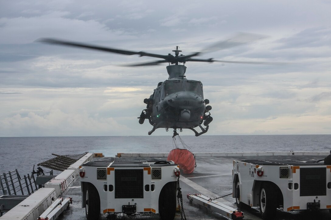 A UH-1Y Venom with Marine Medium Tiltrotor Squadron 161 (Reinforced), 15th Marine Expeditionary Unit, lands with a Bambi Bucket on the flight deck of the USS Anchorage (LPD 23) in the Philippine Sea, June 3, 2015. Marines of the 15th MEU practice firefighting operations to be prepared for potential missions in the future. (U.S. Marine Corps photo by Sgt. Steve H. Lopez/Released)