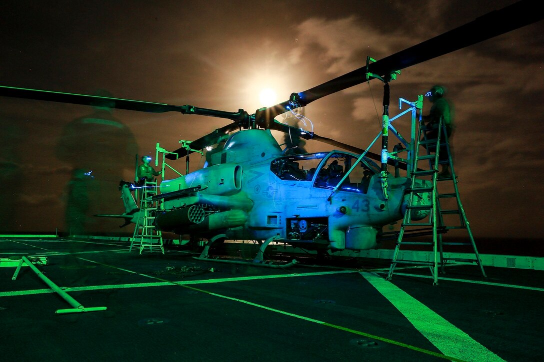 U.S. Marines with Marine Medium Tiltrotor Squadron 161 (Reinforced), 15th Marine Expeditionary Unit, perform post-flight maintenance on an AH-1Z Viper aboard the USS Anchorage (LPD 23) in the Philippine Sea, June 2, 2015.  The Marines of VMM-161 (Rein.) work day and night to ensure the aircraft are mission capable. (U.S. Marine Corps photo by Sgt. Jamean Berry/Released)