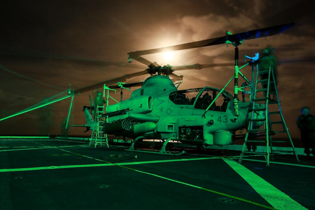 U.S. Marines with Marine Medium Tiltrotor Squadron 161 (Reinforced), 15th Marine Expeditionary Unit, perform post-flight maintenance on an AH-1Z Viper aboard the USS Anchorage (LPD 23) in the Philippine Sea, June 2, 2015. The Marines of VMM-161 (Rein.) work day and night to ensure the aircraft are mission capable. (U.S. Marine Corps photo by Sgt. Jamean Berry/Released)