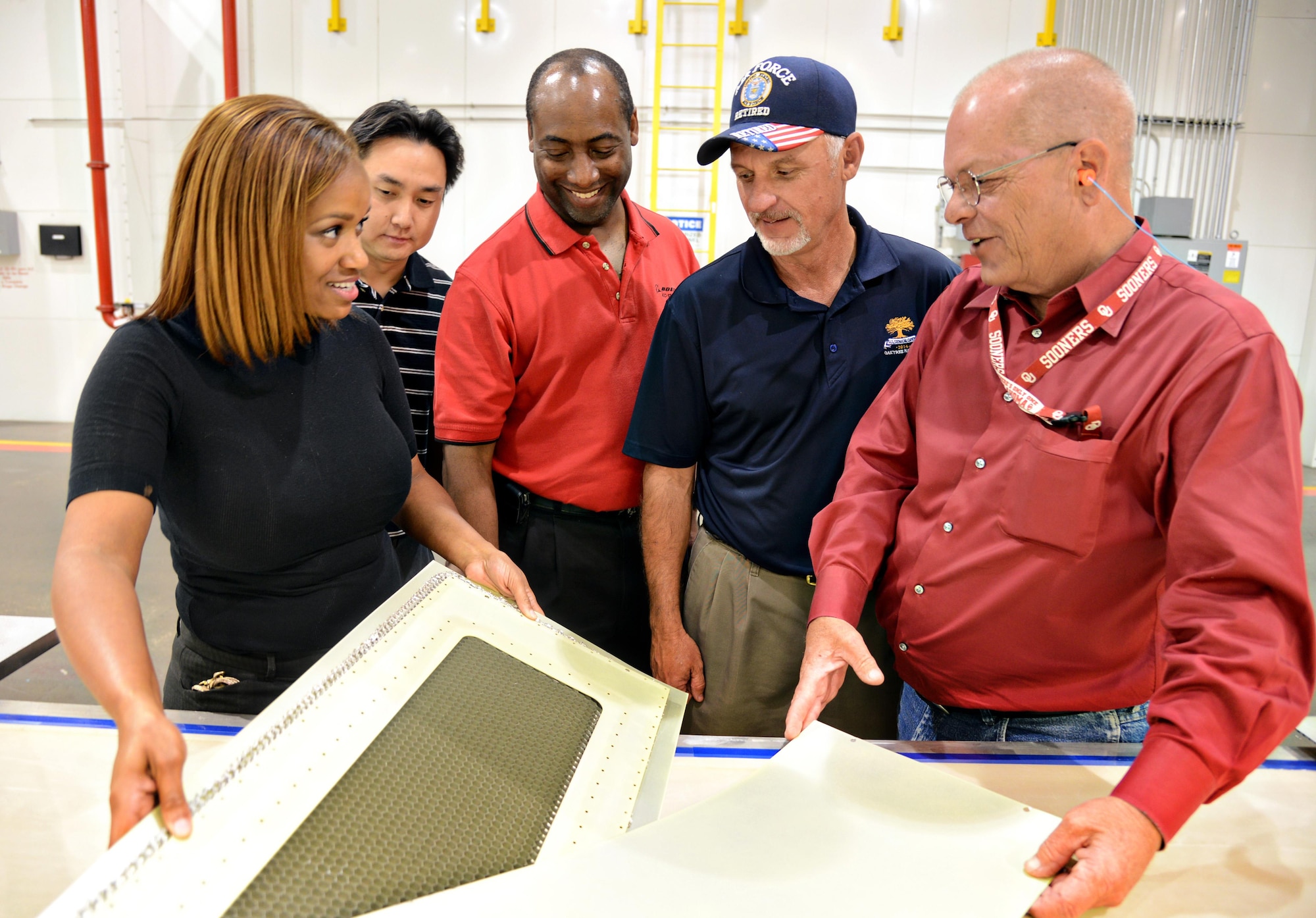 Sharmeitra Threatt, Harris Chandra, Keith Gray and Danny Thompson, members of the 424th Supply Chain Management Squadron, talk about the KC-135 Stratotanker balance panel overhaul process with Dan Mitchell from the 551st Commodities Maintenance Squadron at Tinker Air Force Base, Okla. The base can now make and overhaul these panels instead of ordering new ones. (Air Force photo/Kelly White) 