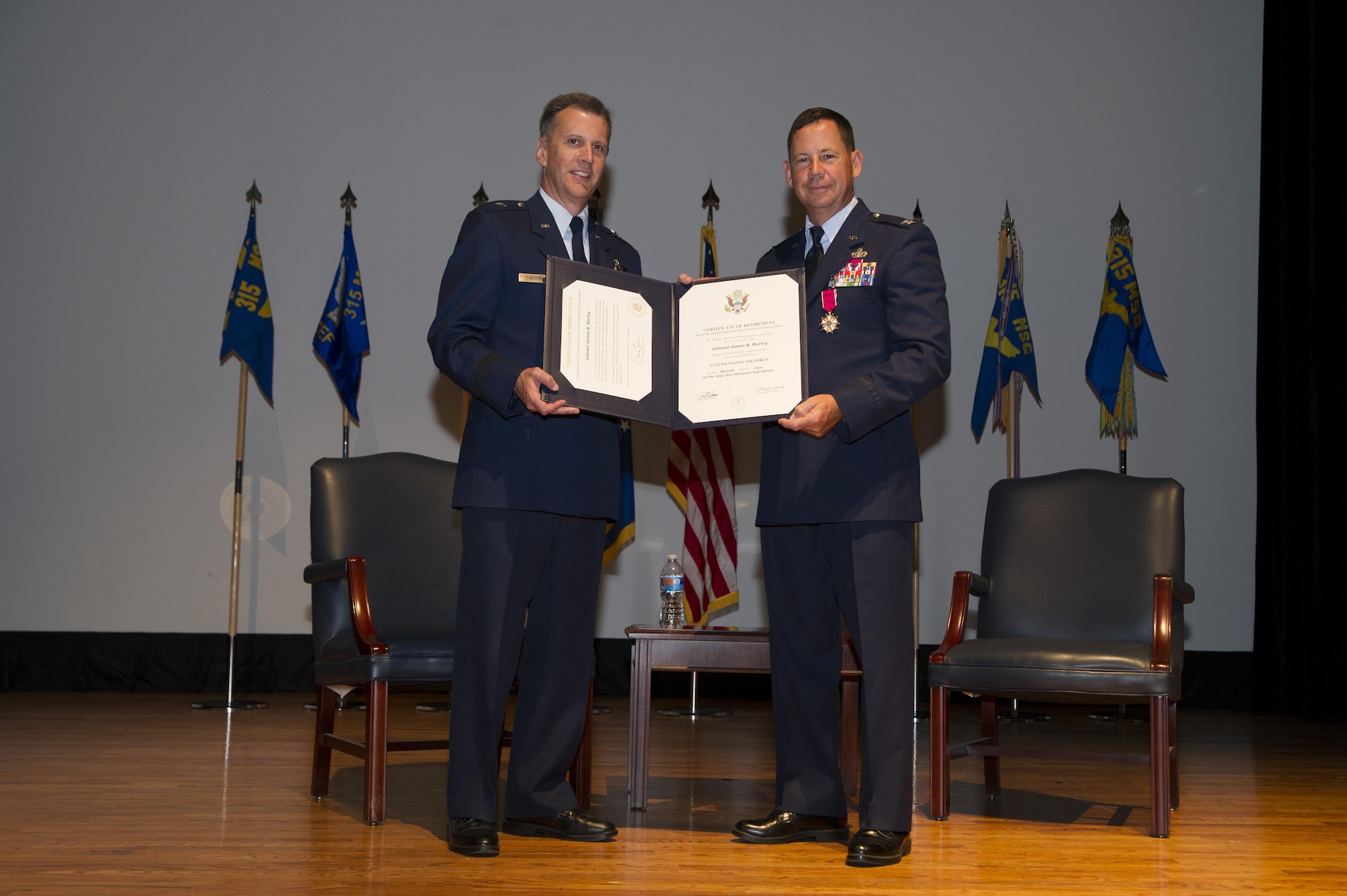 Brig. Gen. Randall A. Ogden presents a certificate of retirement to Col. James B. Hurley June 7, 2015 at the Joint Base Charleston theater in Charleston, S.C. During his 33-33-year career, Hurley first served with the active duty Air Force before transitioning to the Air Force Reserve. Hurley donned the Air Force uniform for the last time but will go on to serve in a civilian capacity with the 628th Air Base Wing Mission Support Group at the base. Hurley was the 315th Mission Support Group commander at Joint Base Charleston, and Ogden is the Director, Air Force Reserve Plans, Programs and Requirements, Headquarters U.S. Air Force. (U.S. Air Force Photo by Tech. Sgt. Shane Ellis)