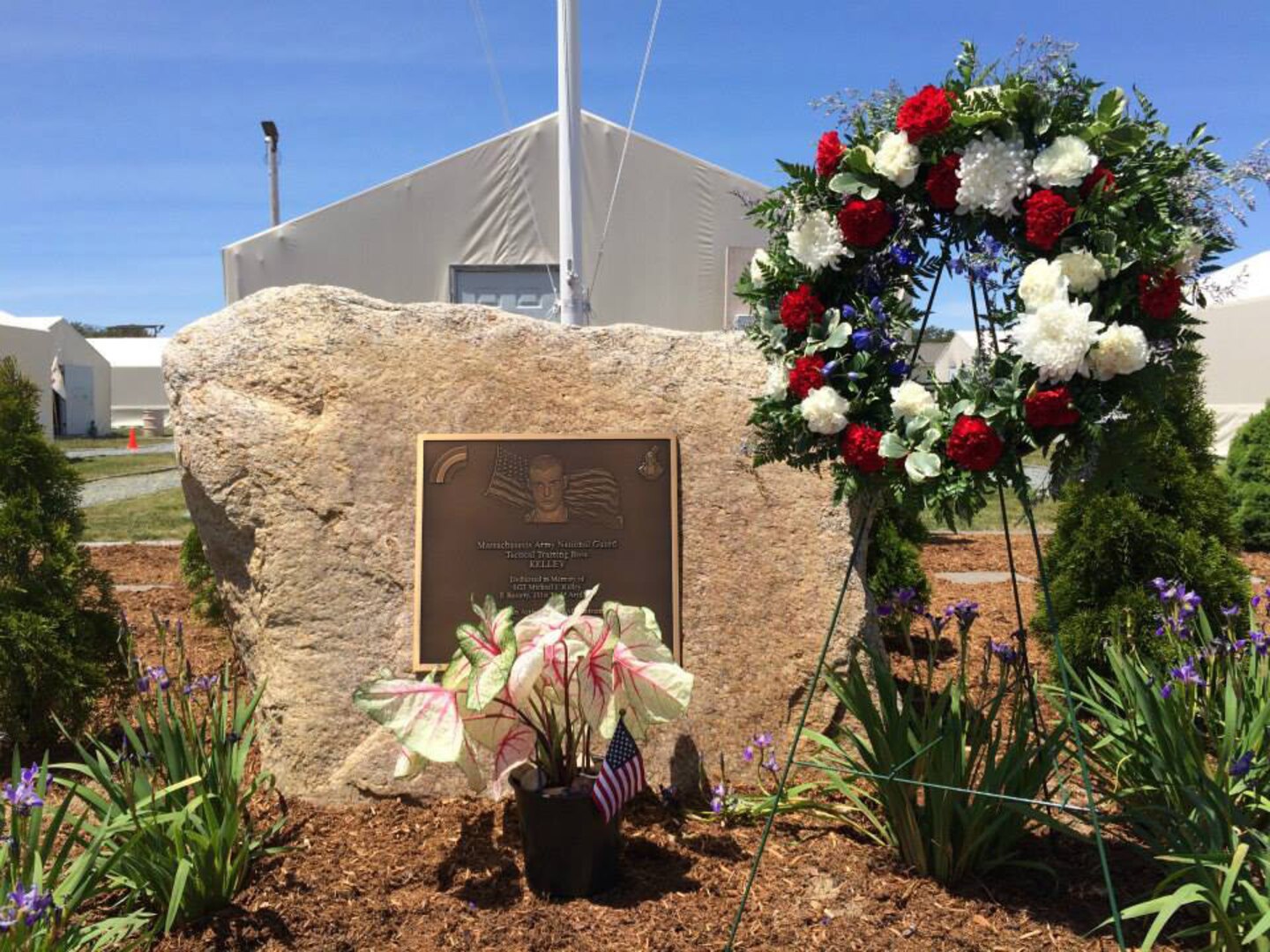 Friends and Family gathered together to honor the memory of Sgt. Michael J. Kelley during a wreath-laying ceremony and helicopter flyover at Tactical Training Base Kelley on Camp Edwards June 7, 2015. Kelley was killed in action while serving in Afghanistan in 2005 in support of Operation Enduring Freedom.