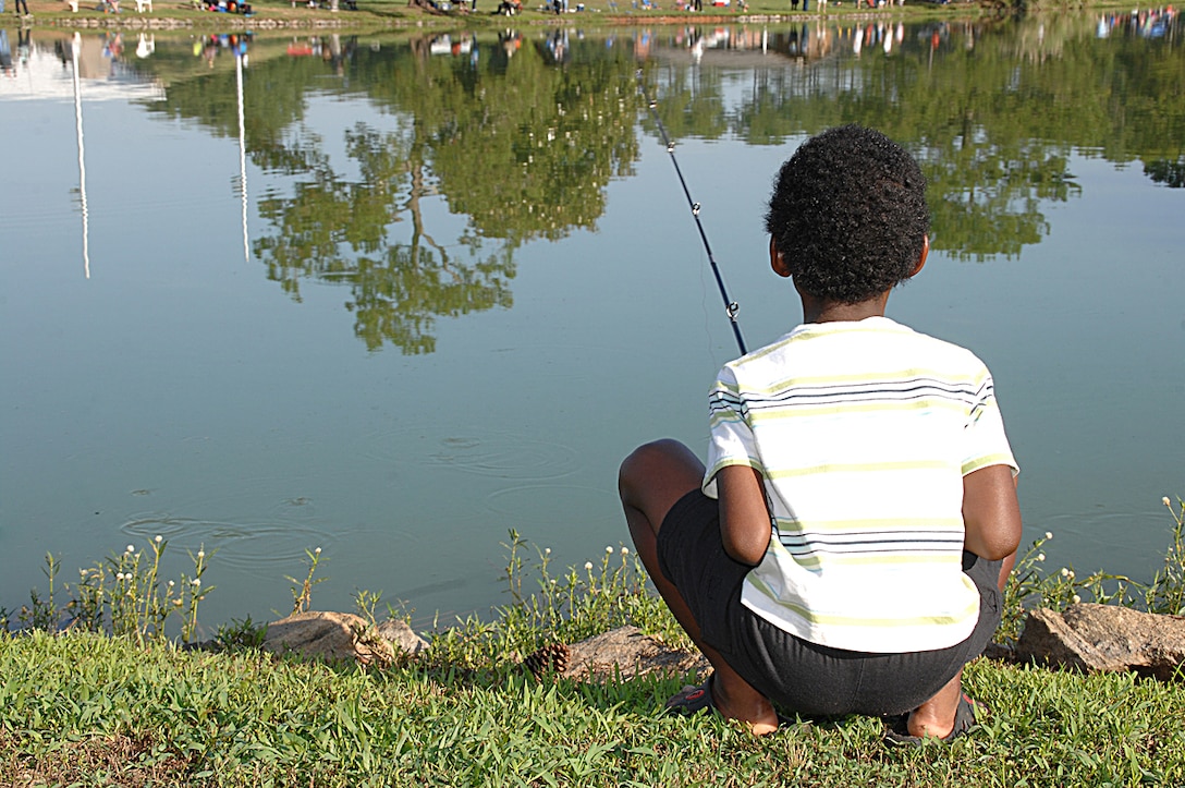 A young angler patiently watches his bobber, hoping for the big one, during Marine Corps Logistics Base Albany’s 27th annual Buddy Fishing Tournament at Covella Pond here, June 6.