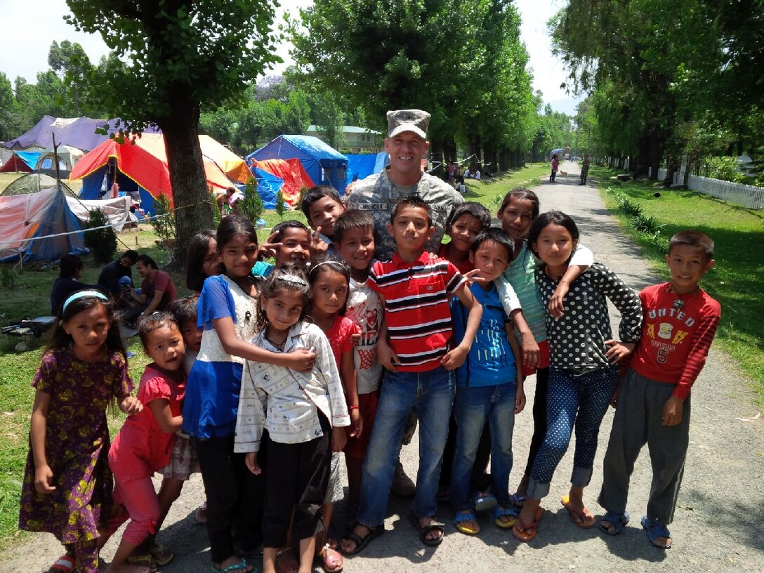 The Commanding General of U.S. Army Corps of Engineers Pacific Ocean Division, Brig. Gen. Jeffrey L. Milhorn, is surrounded by children from a displaced encampment in Nepal. Milhorn served as the Deputy Commanding General-Support for Joint Task Force (JTF) 505 for Operation Sahayogi Haat, which means “Helping Hand” in Nepali.  JTF 505 worked in support of U.S. Agency for International Development’s Office of U.S. Foreign Disaster Assistance to provide unique military capabilities in response to the Nepal Earthquake relief efforts.