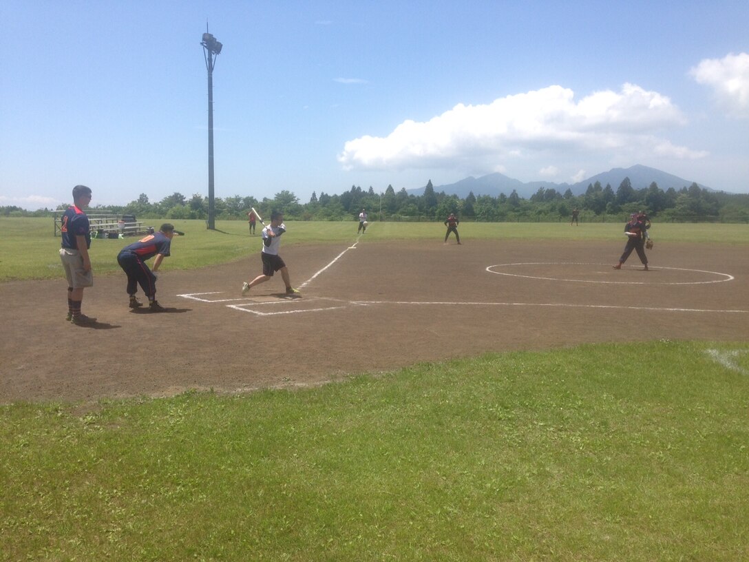 Cpl Curtis winds up to deliver a pitch during the 1st Annual Camp Fuji - JGSDF - Fuji Friendship Association Sports Tournament.