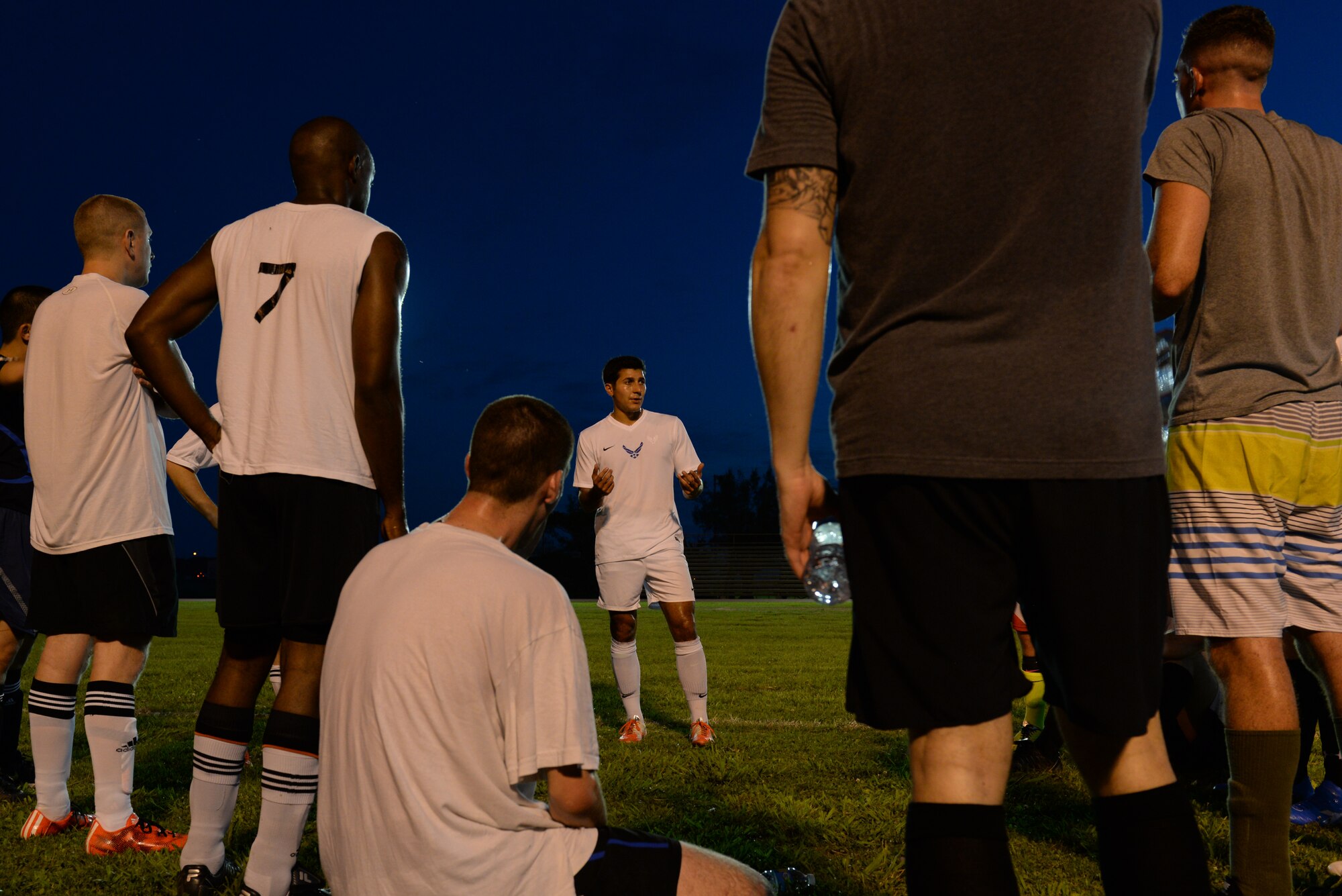 Teammates listen to U.S. Air Force 1st Lt. Aaron Zendejas, 961st Airborne Air Control Squadron air battle manager and mid-fielder, during an intramural soccer match at the Risner Fitness Center on Kadena Air Base, Japan, June 2, 2015. Zendejas and his U.S. Air Force Men's Soccer teammates brought home the silver medal during the All Armed Forces Soccer Tournament May 21, 2015. (U.S. Air Force photo by Senior Airman Omari Bernard)